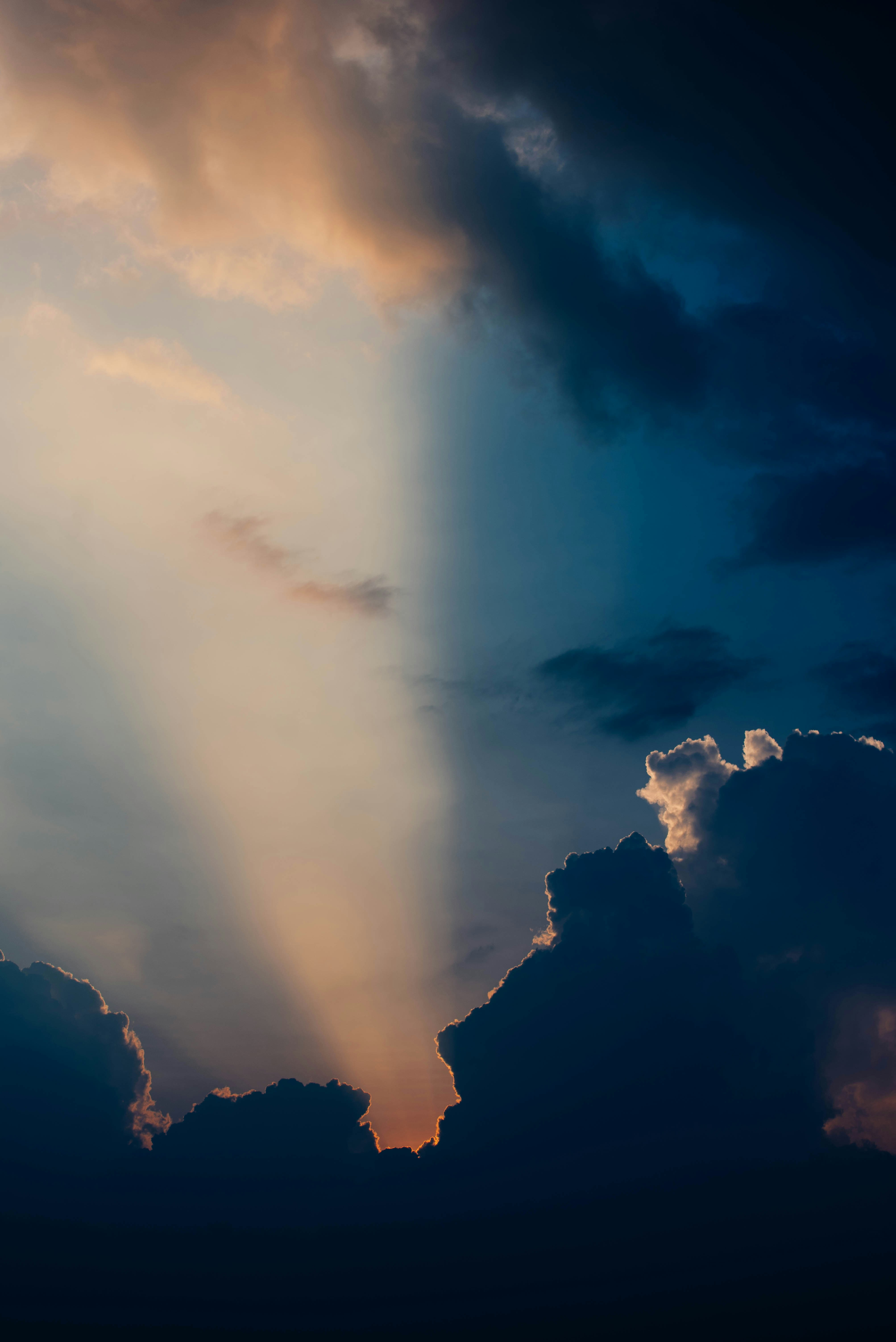 Sunbeams through dark clouds at sunset