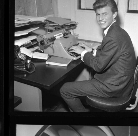 Young Man Typing At Office Desk