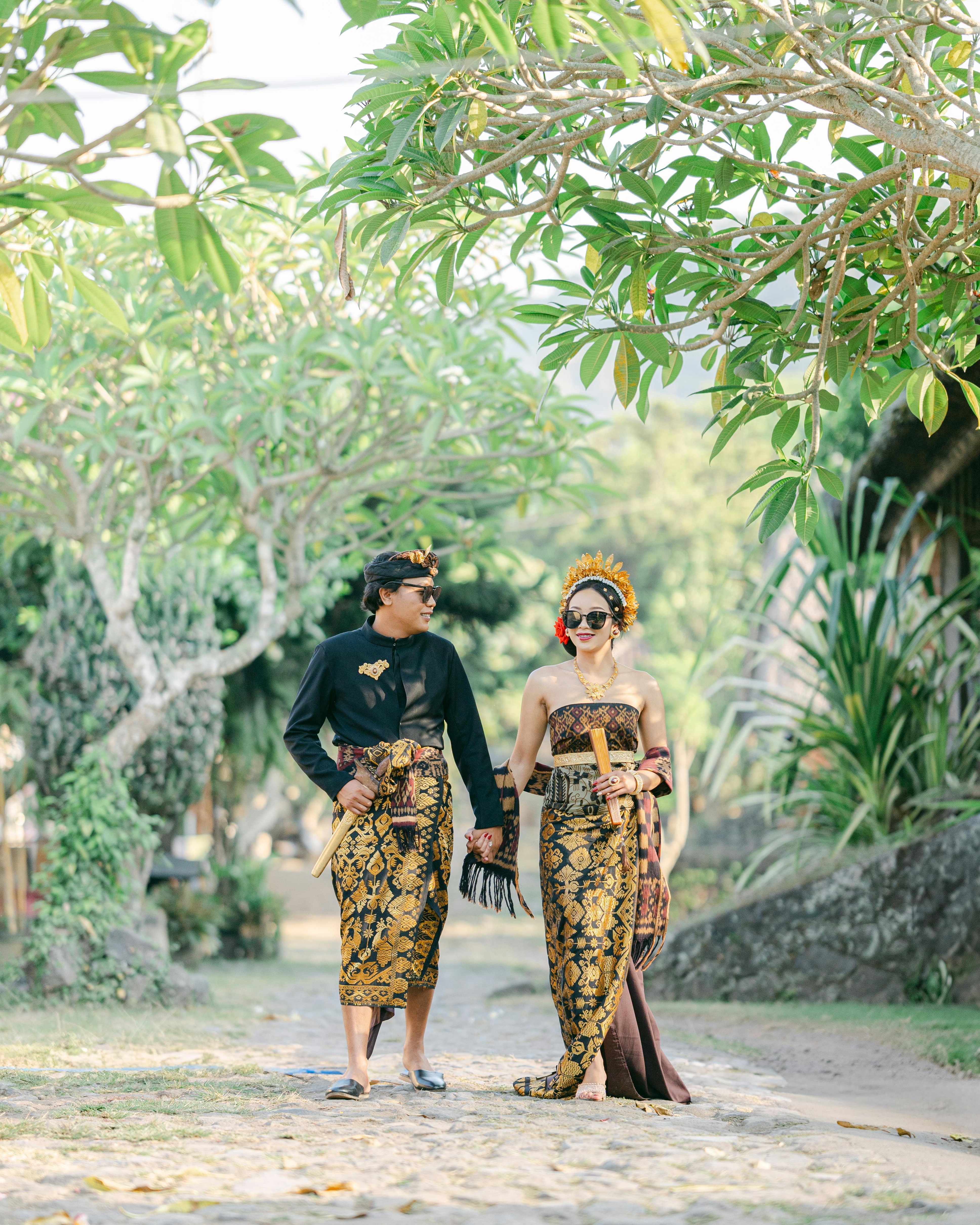 Couple in Traditional Indonesian Attire Walking