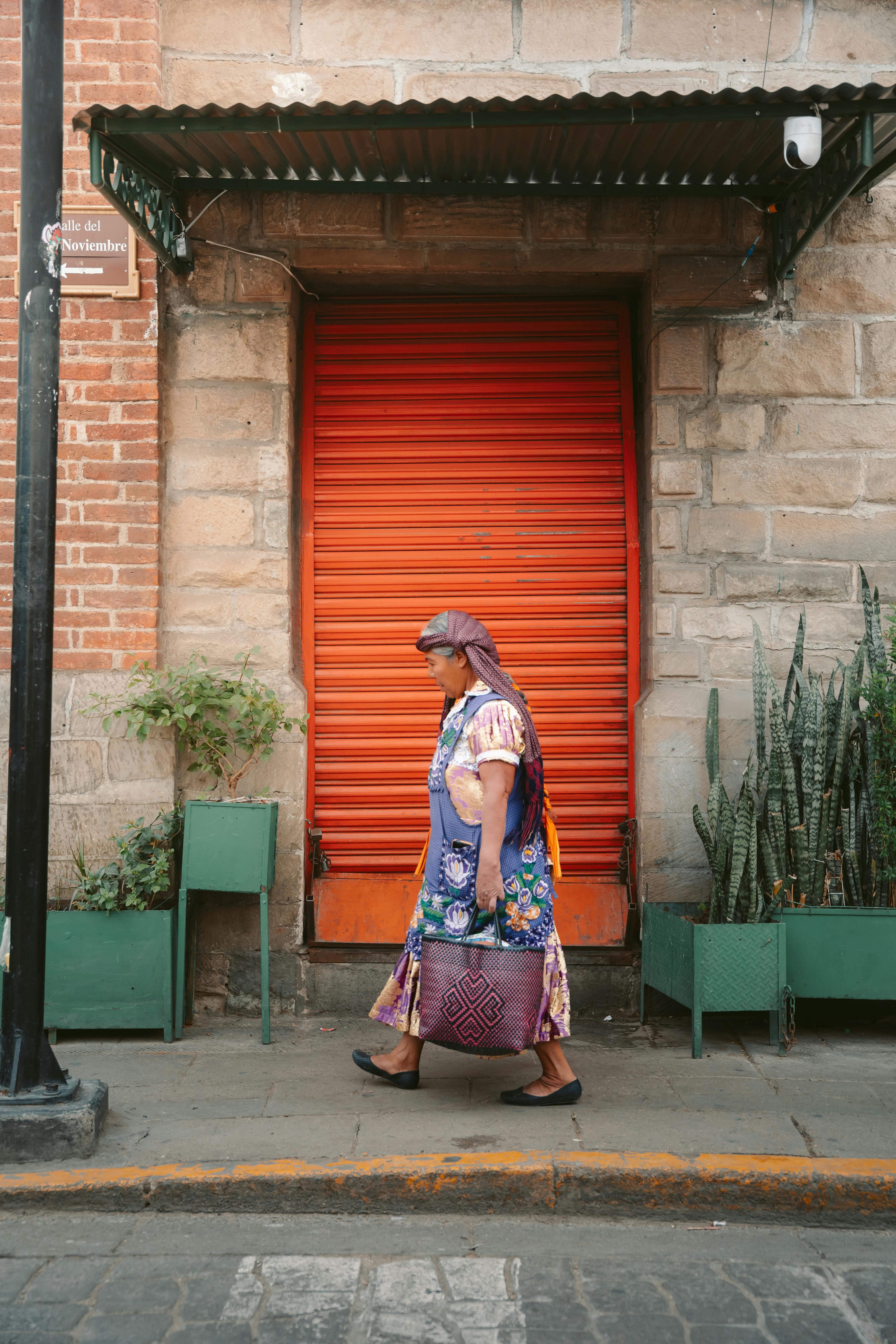 Indigenous Woman Walking Past Closed Shop