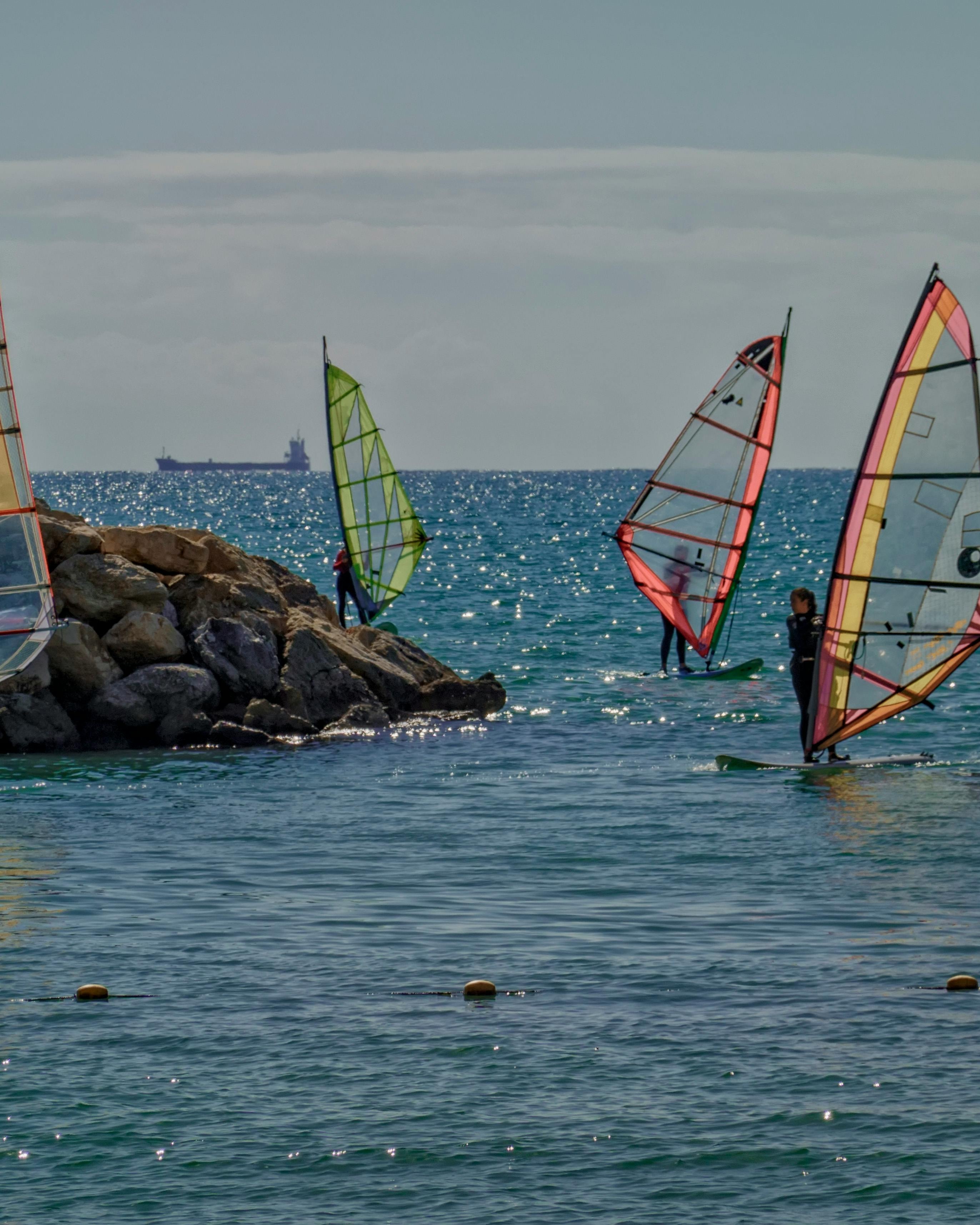 Windsurfers on Calm Coastal Waters
