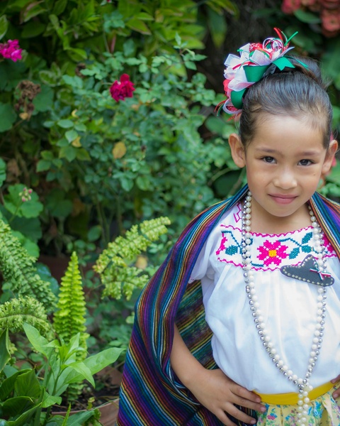 Girl in Traditional Mexican Dress in Garden