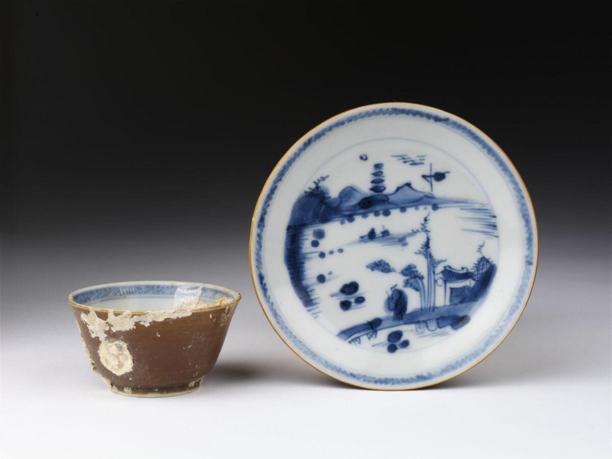 Brown glazed cup with blue and white saucer