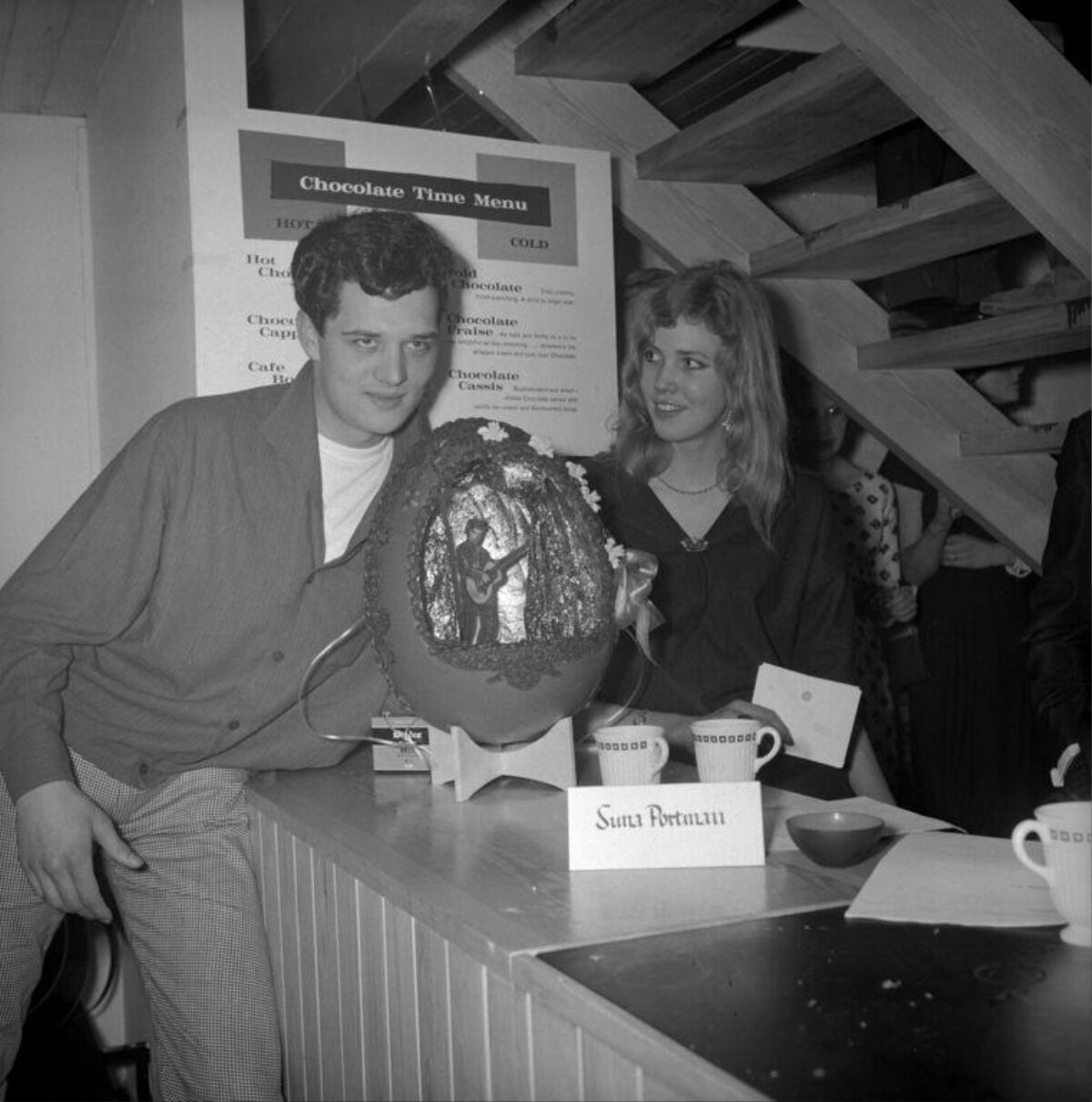 Two People With Giant Decorated Chocolate Egg