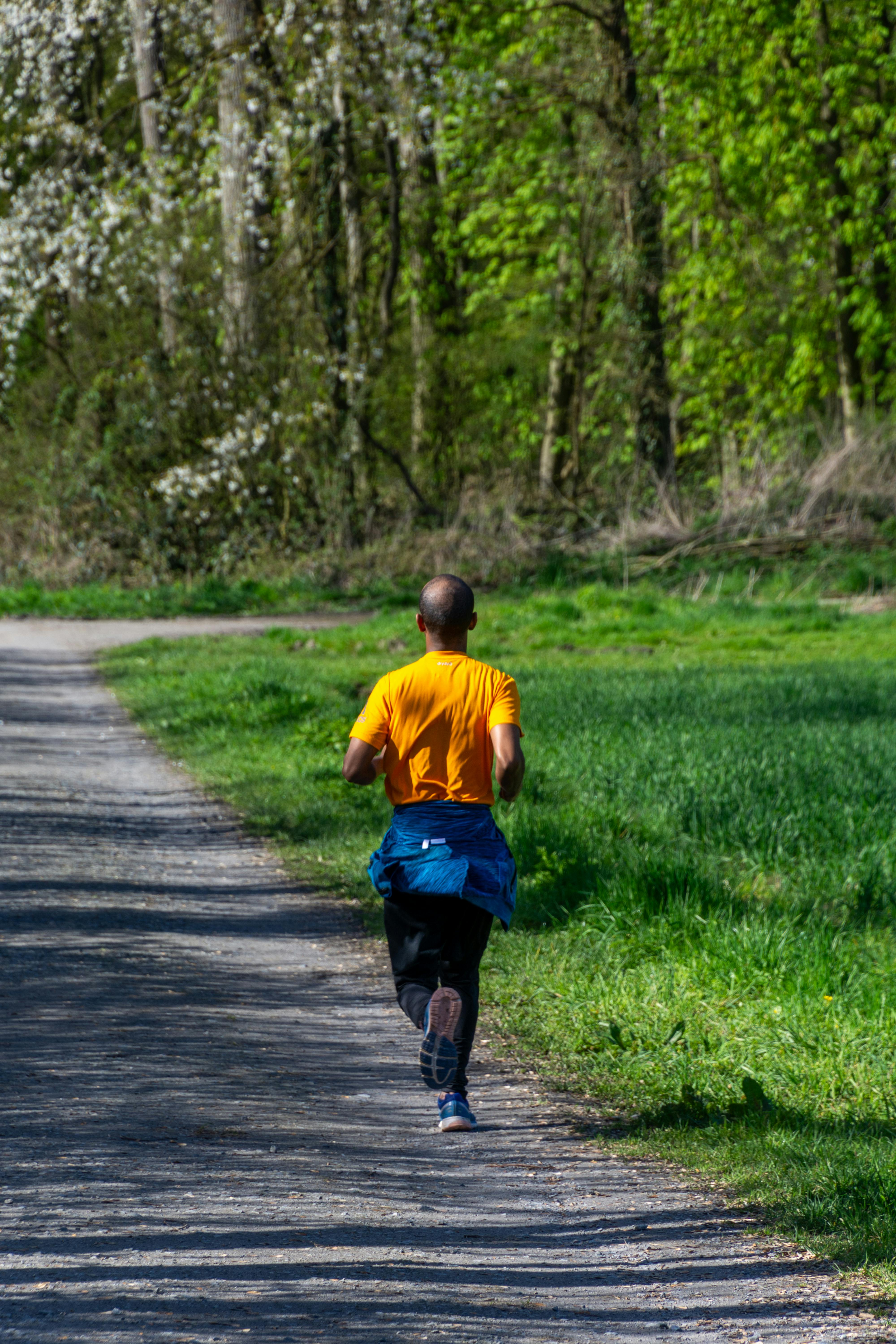 Man Jogging on Park Gravel Path