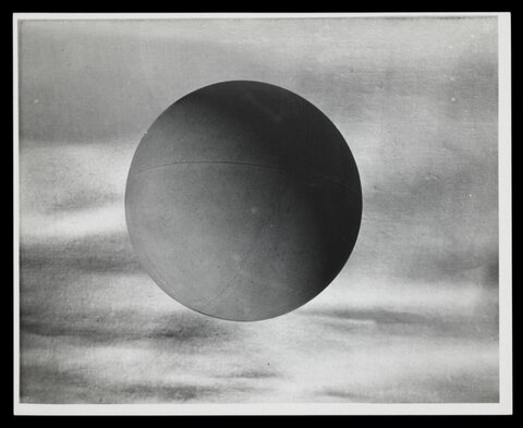 Dark Sphere Against Blurred Sky