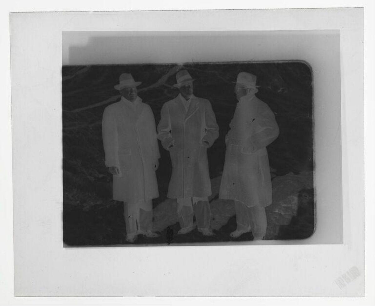 Film Negative of Three Standing Men