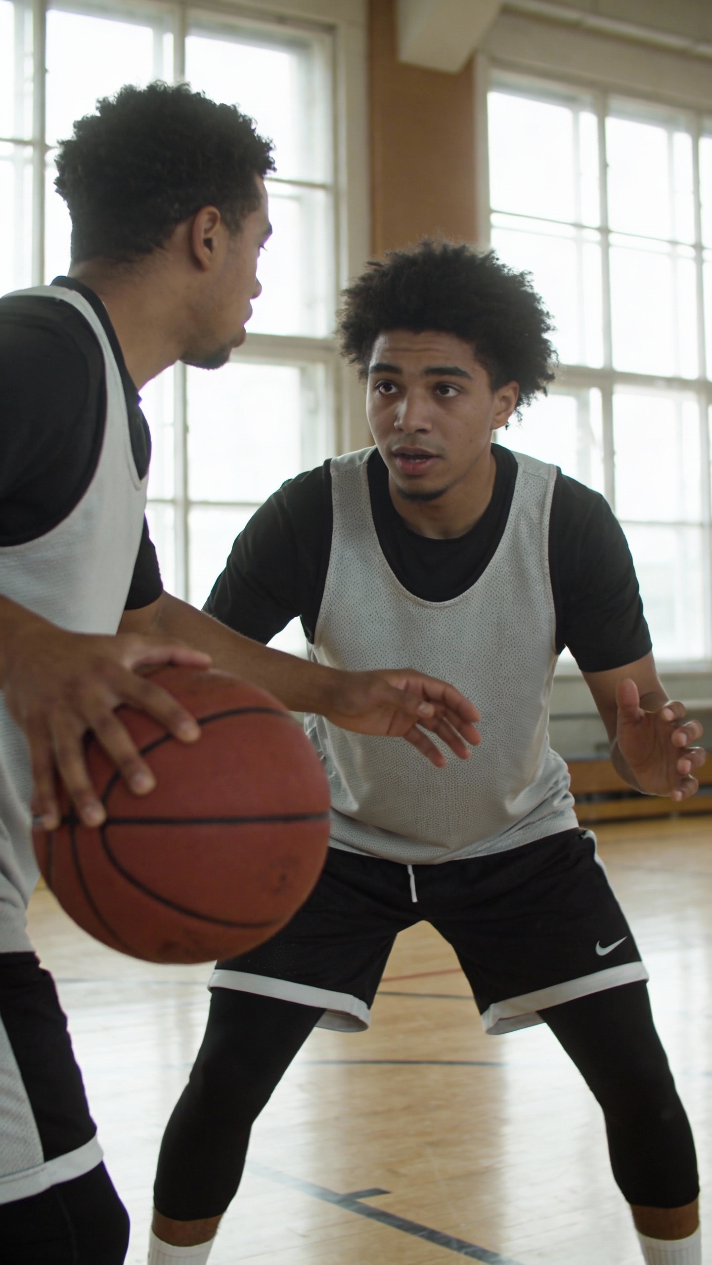 Two Men Playing Basketball in Gym