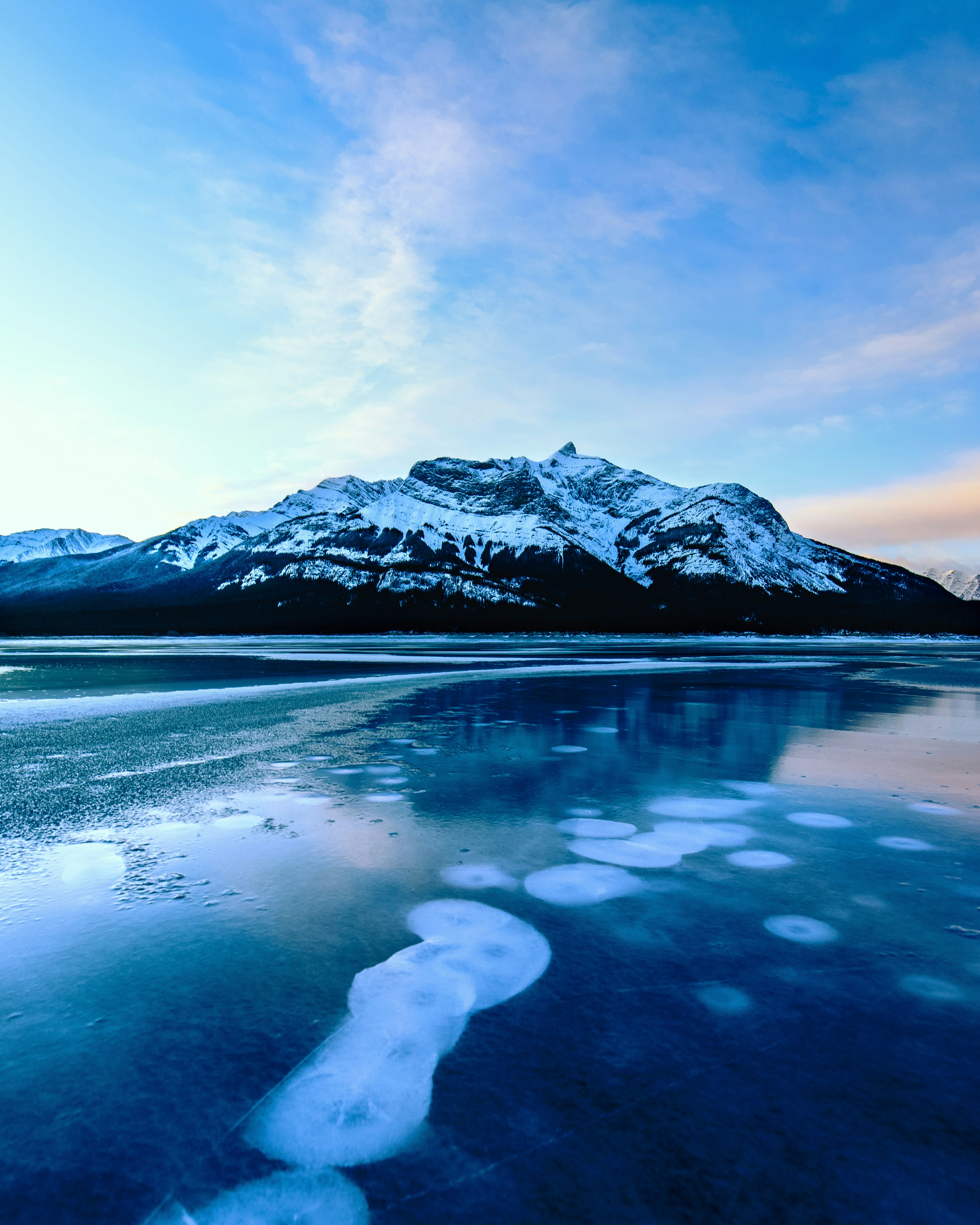 Frozen Lake Beneath Snowy Mountains