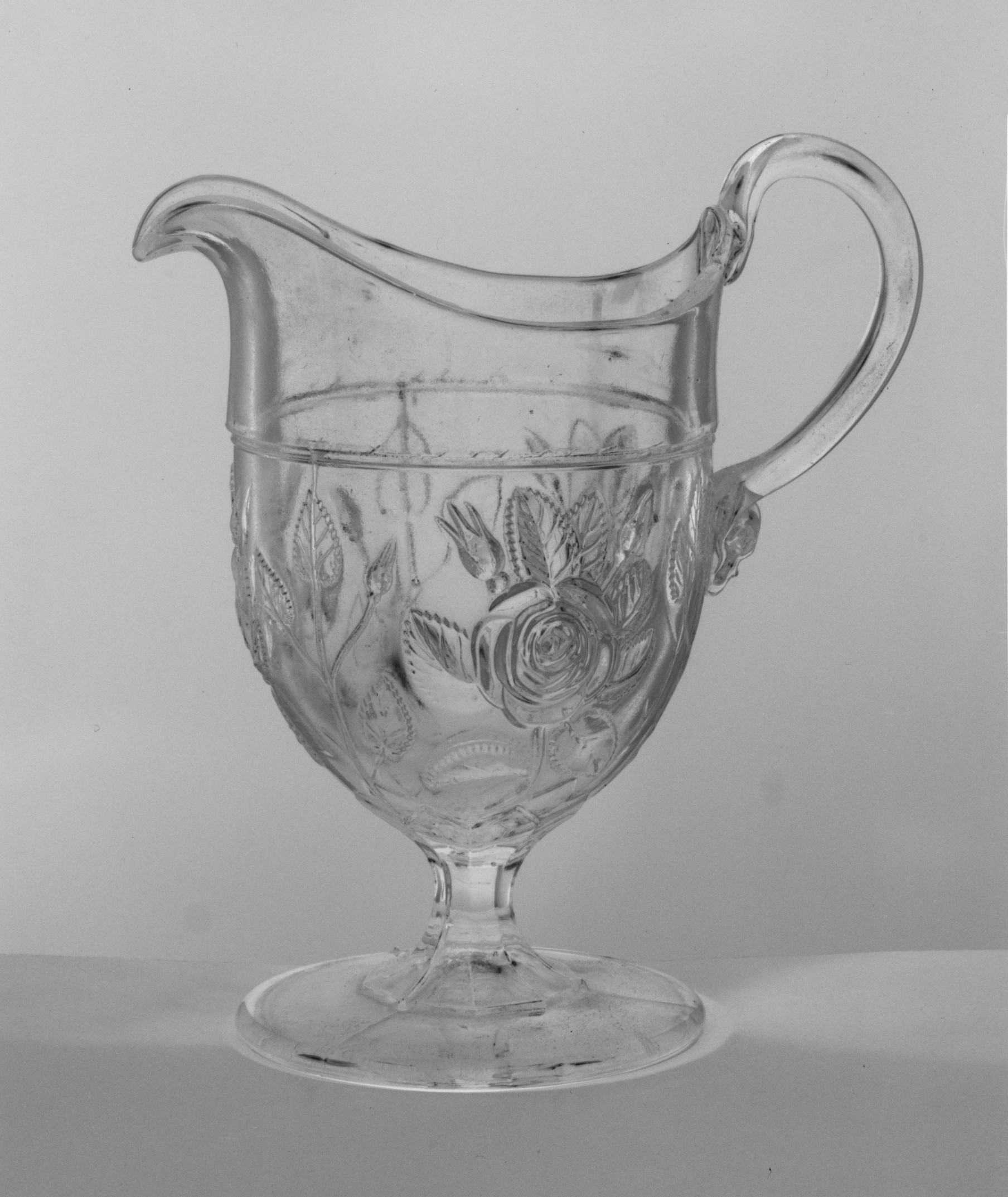 Rose Patterned Footed Glass Pitcher