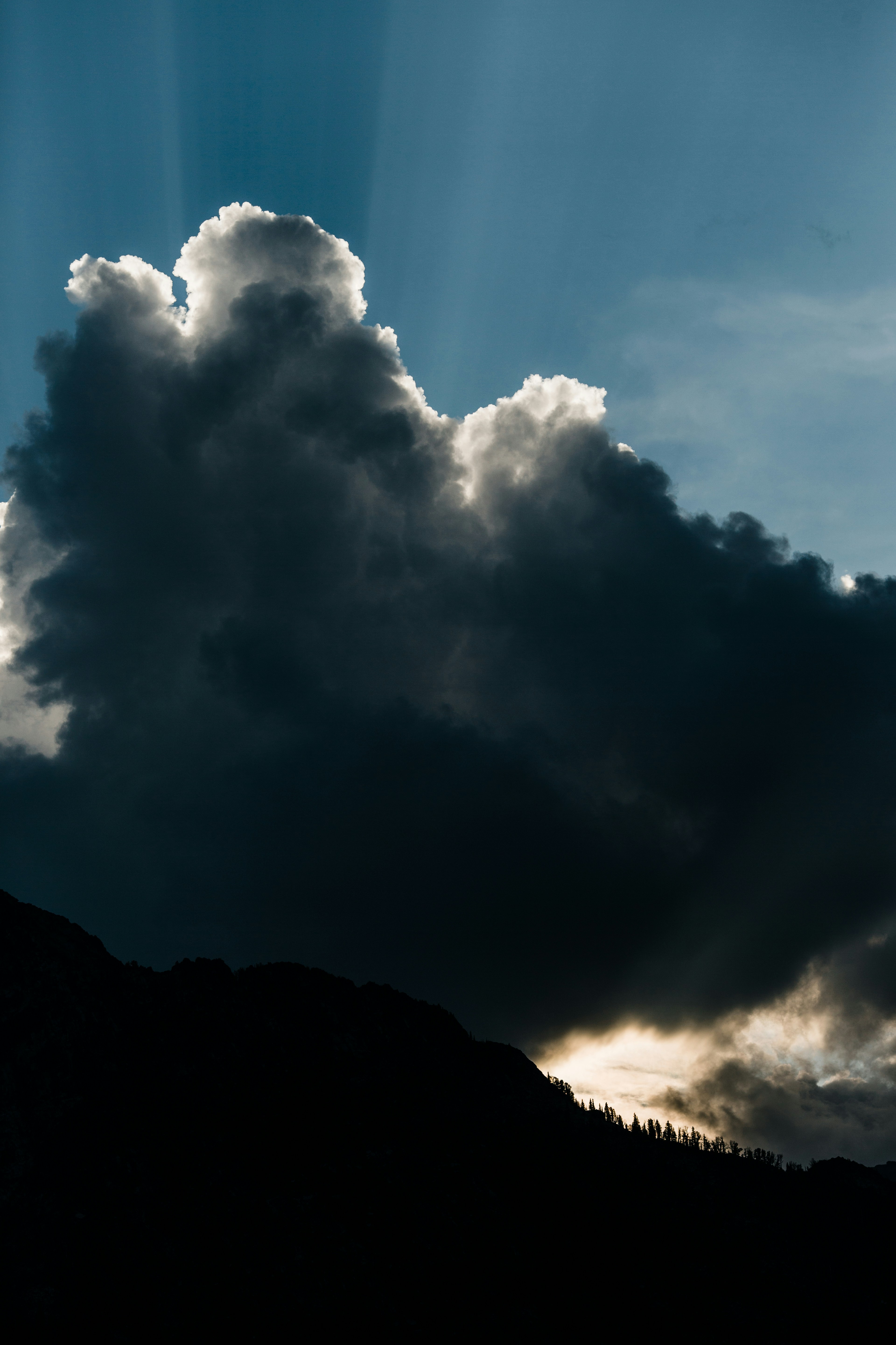 Backlit Giant Cloud Over Mountain Silhouette