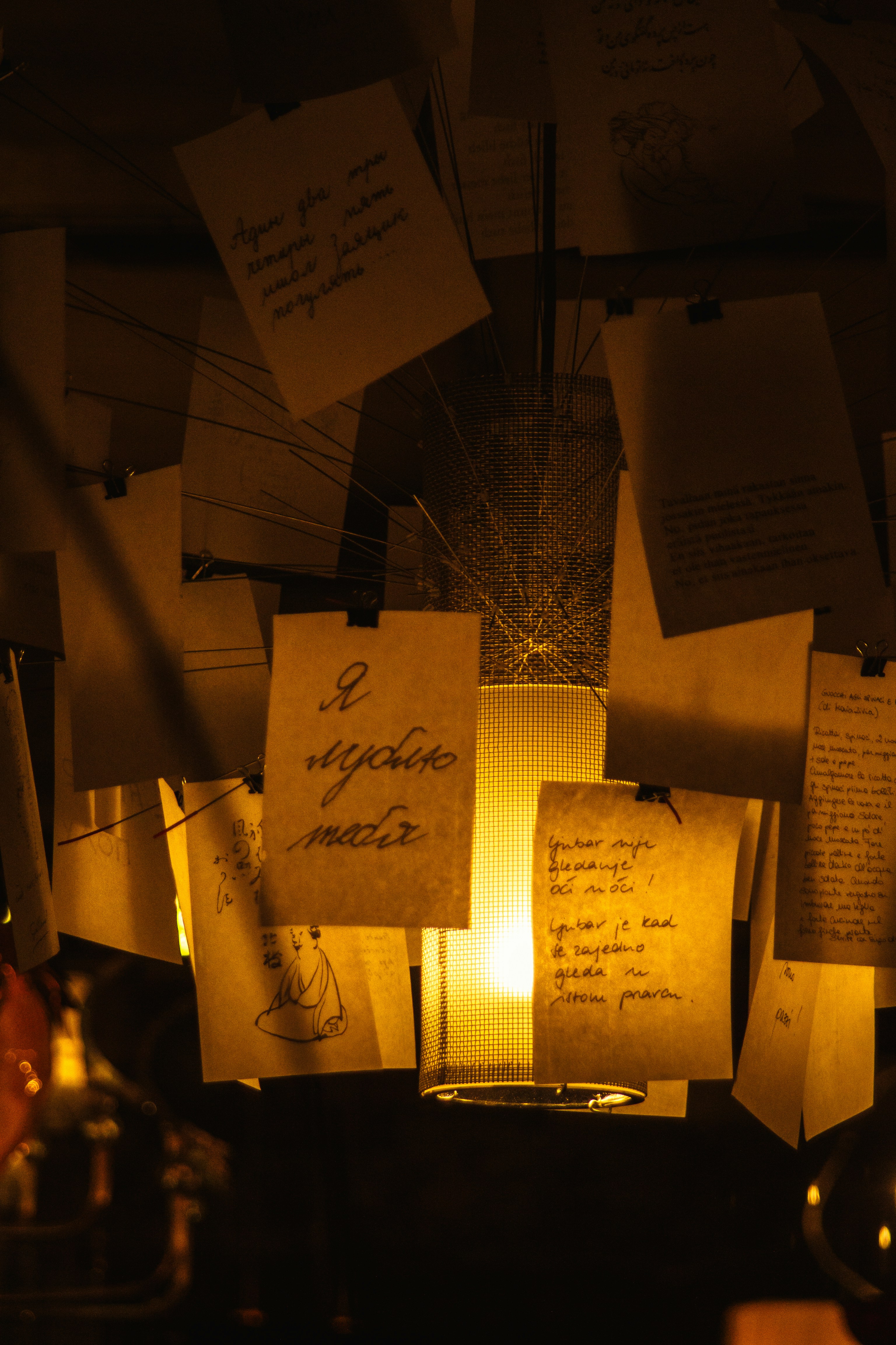 Handwritten Notes Around Warm Glowing Lamp
