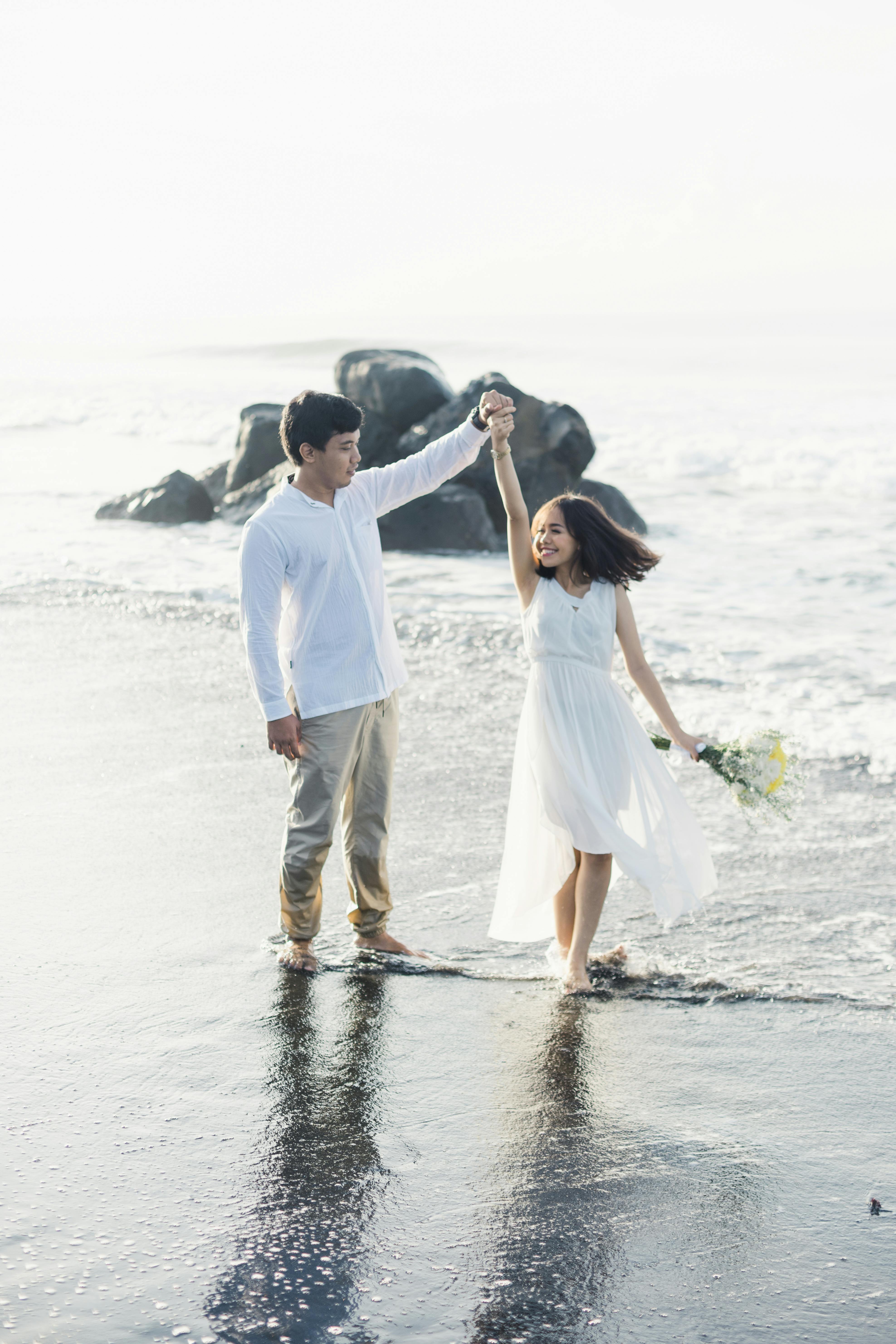 Happy Couple Dancing on Beach