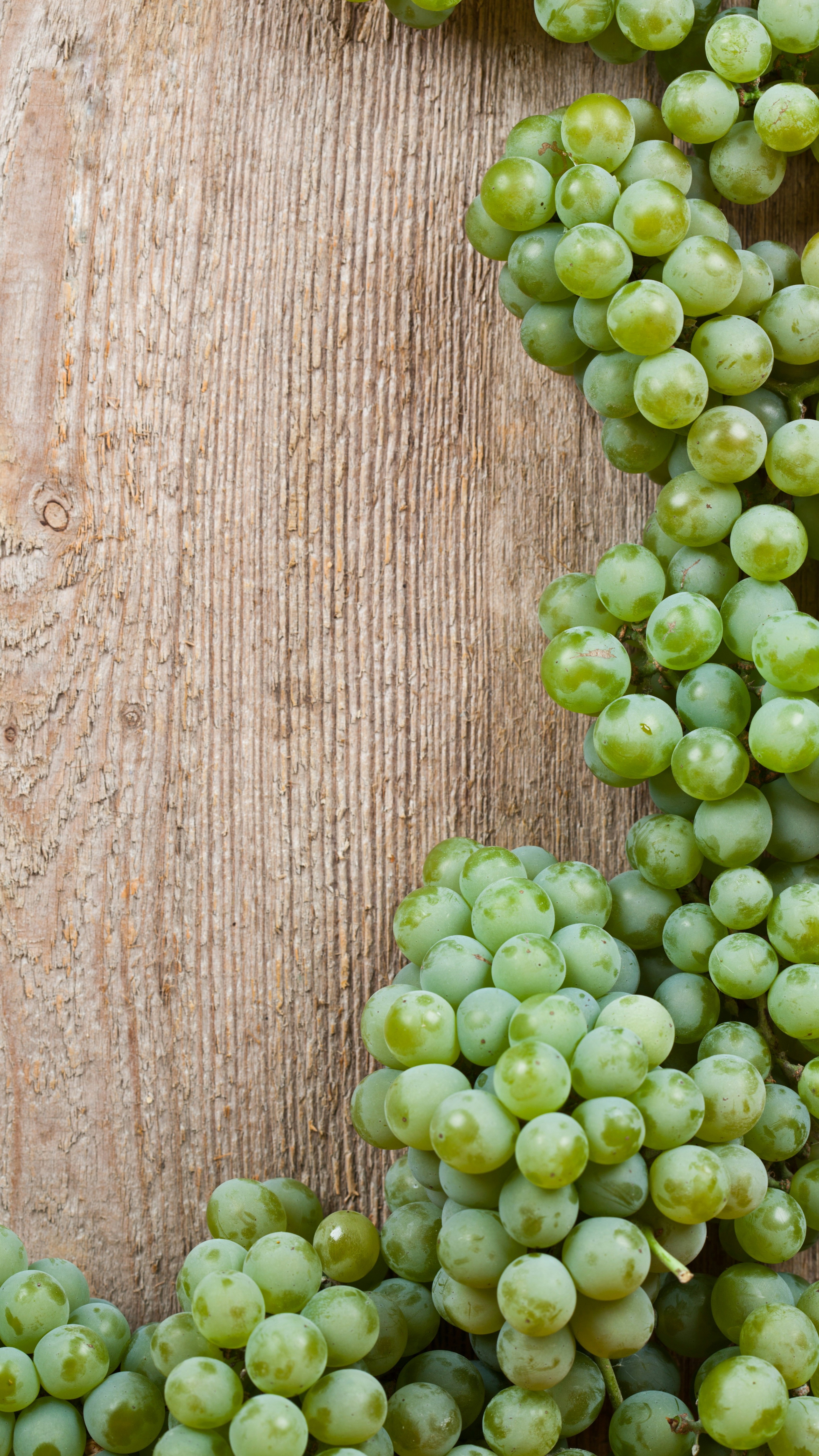 Green Grapes on Weathered Wood