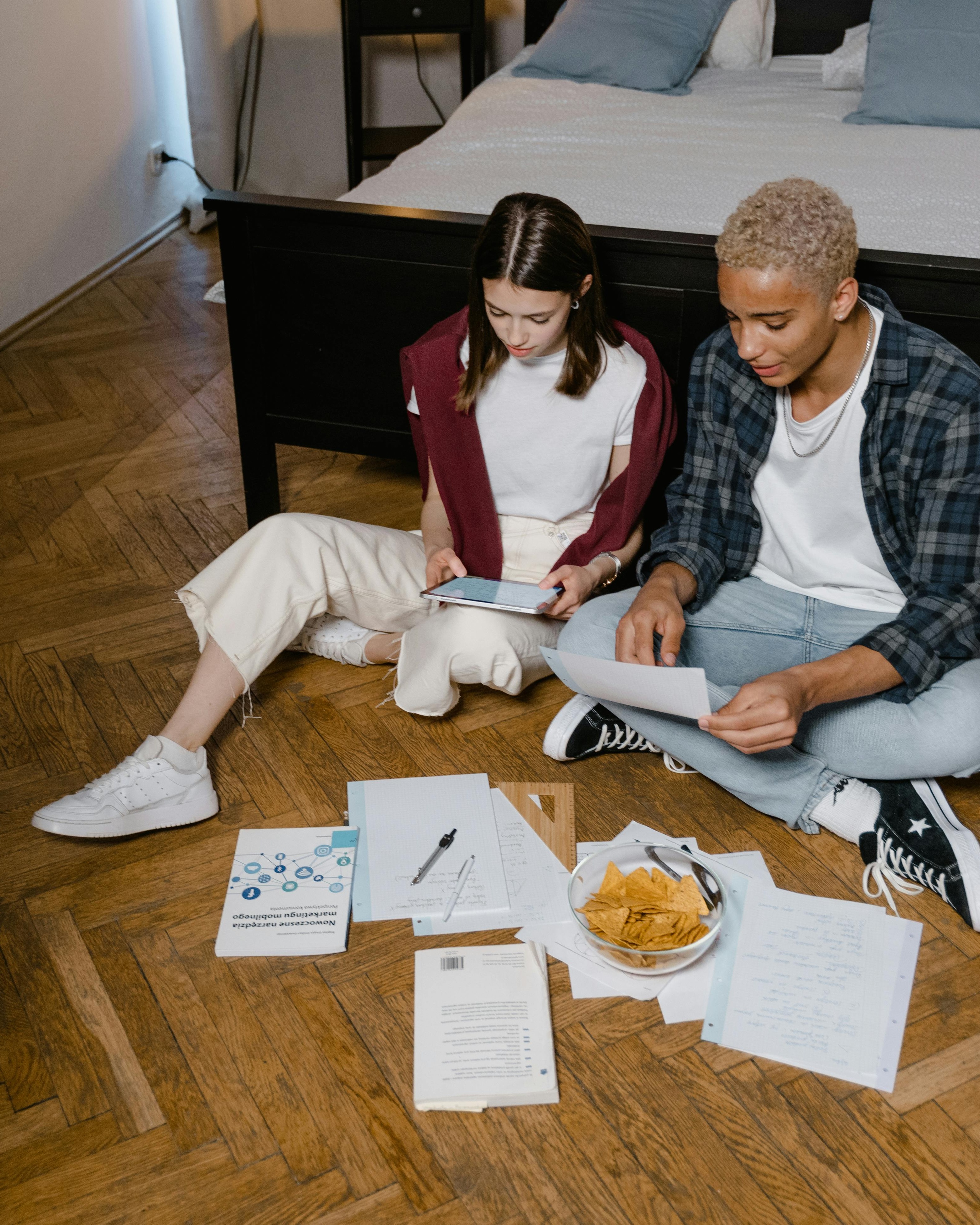 Two Students Studying on Floor