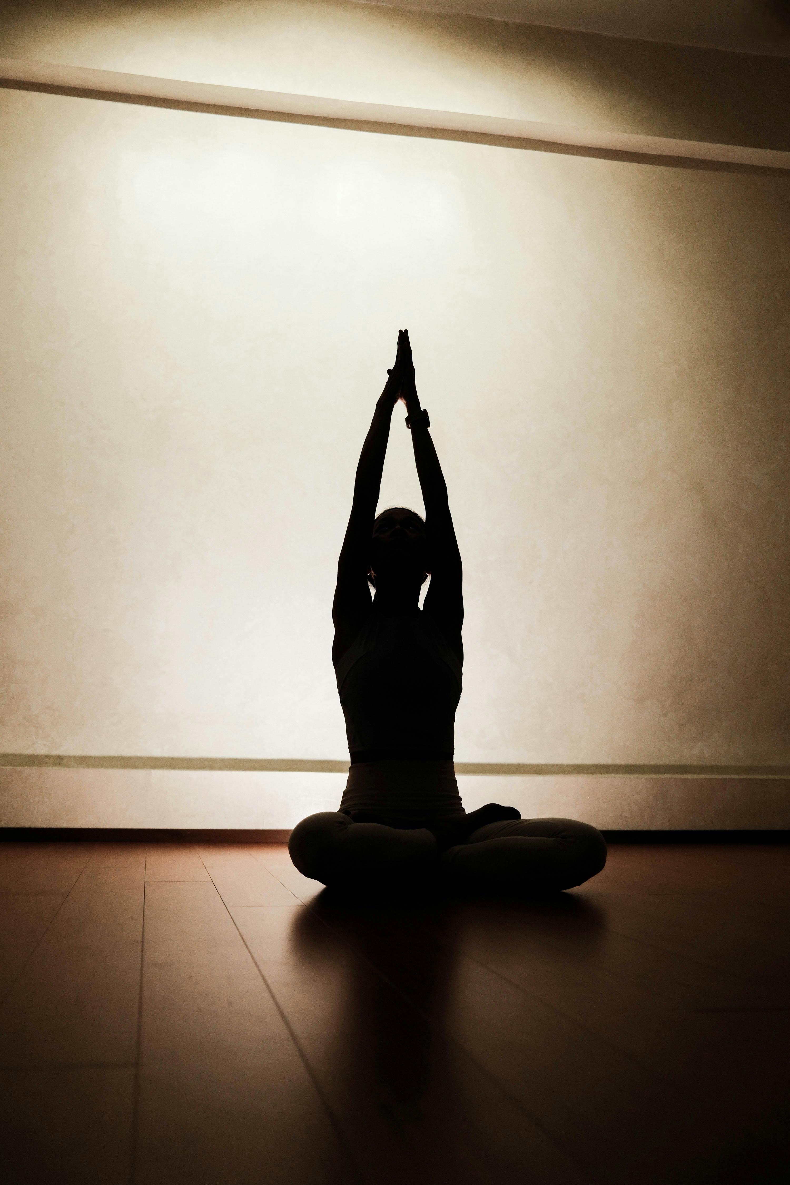Silhouette of Person Practicing Yoga