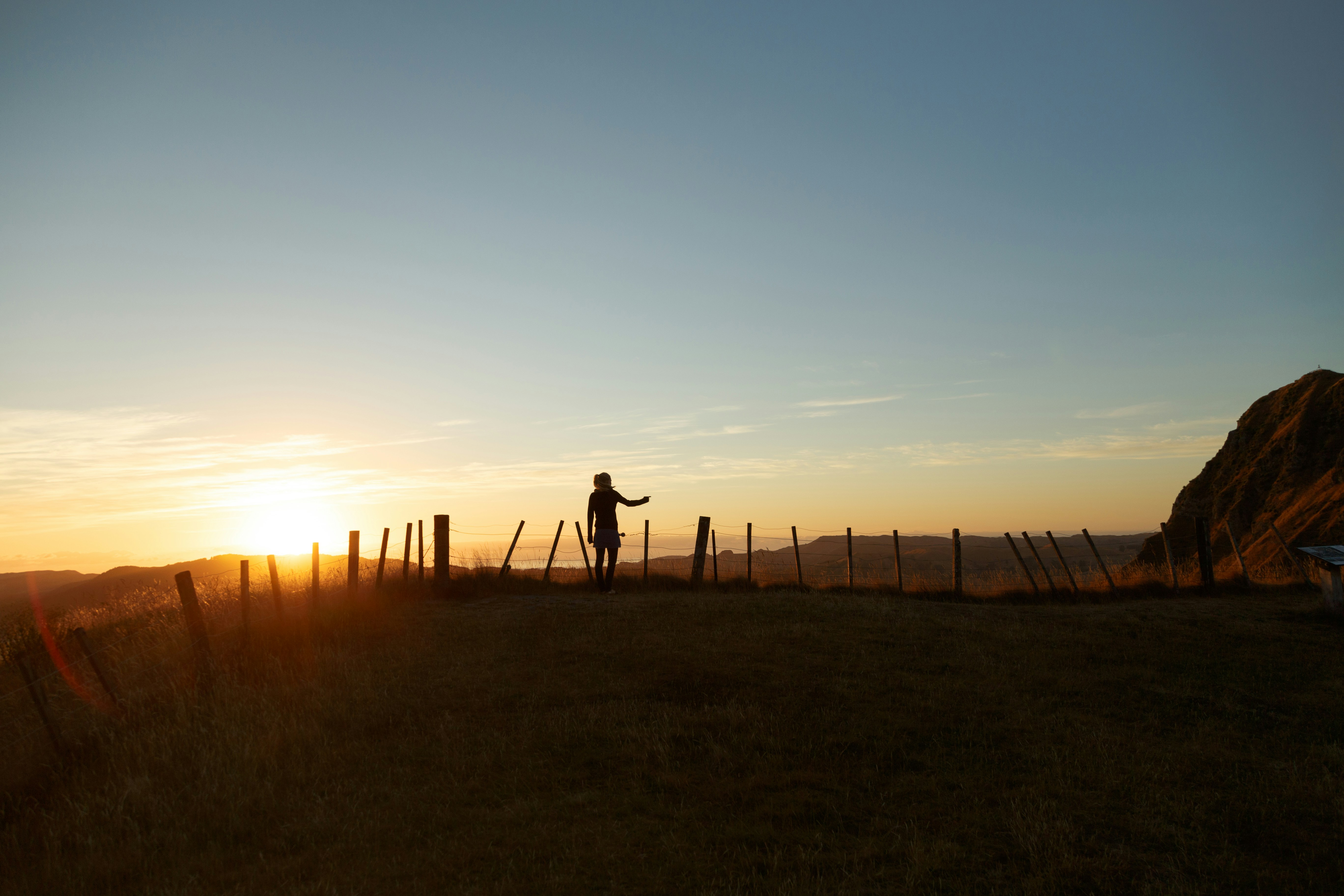 Hiker Silhouette At Hillside Sunset