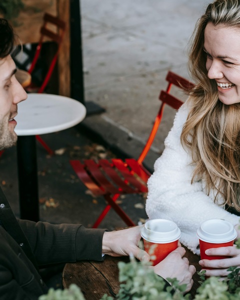 Couple Enjoying Coffee at Outdoor Cafe