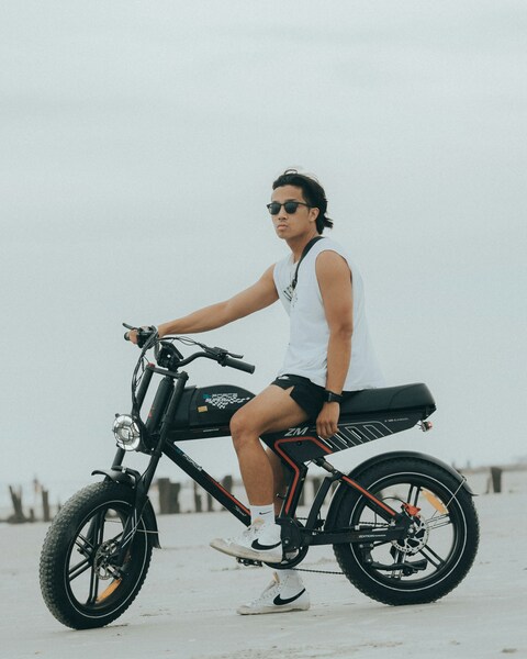 Young Man On E-bike At Beach