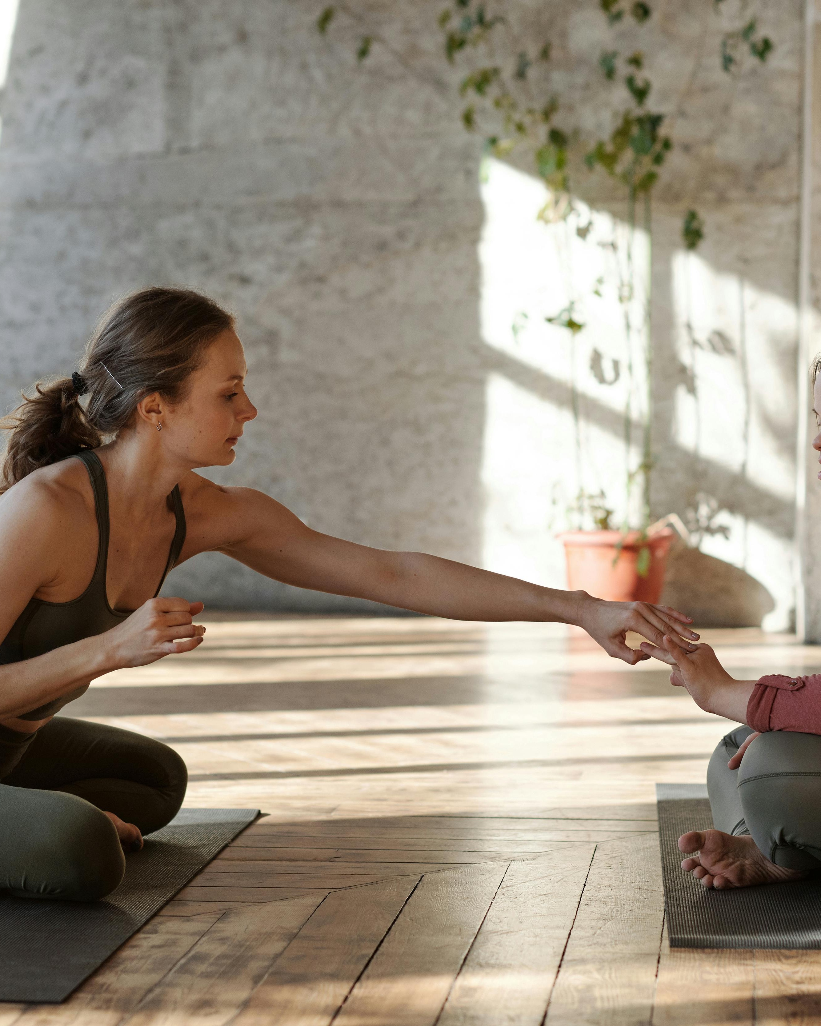 Yoga Instructor Guiding Student