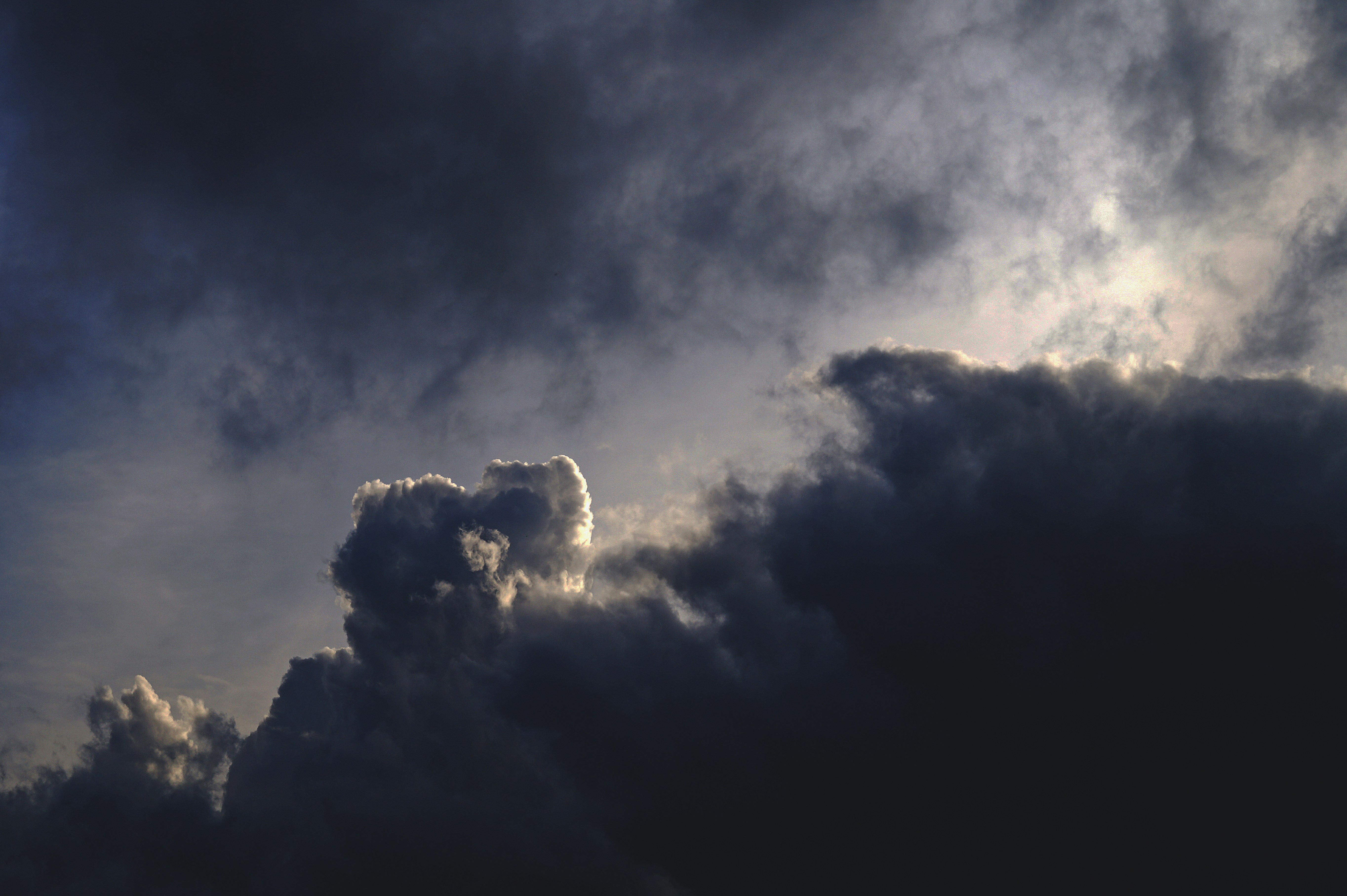 Sun Breaking Through Dark Storm Clouds