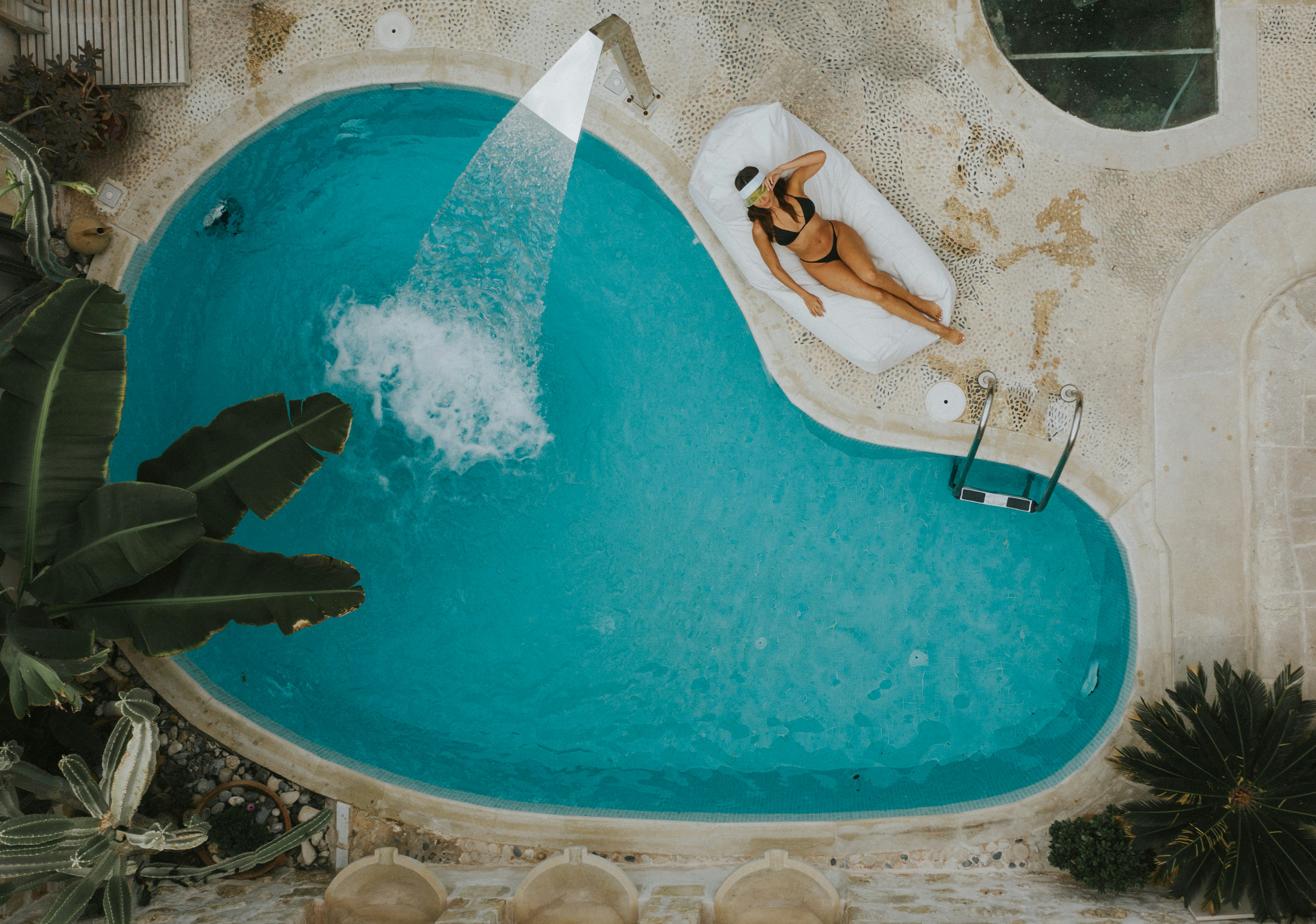 Woman Relaxing Beside Private Pool