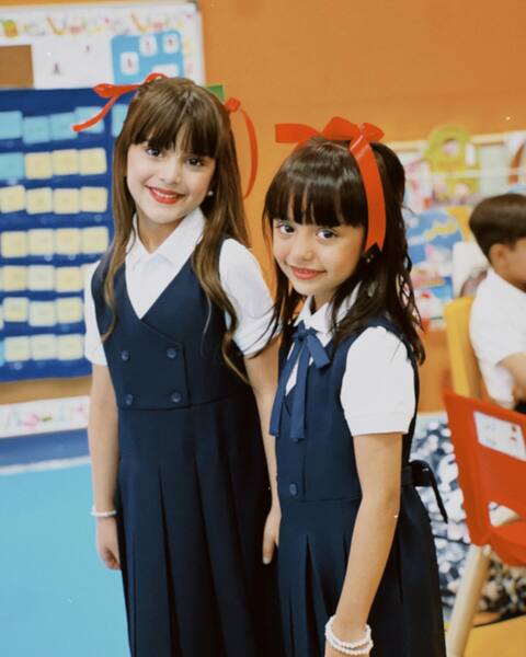 Two Schoolgirls In Classroom Uniforms