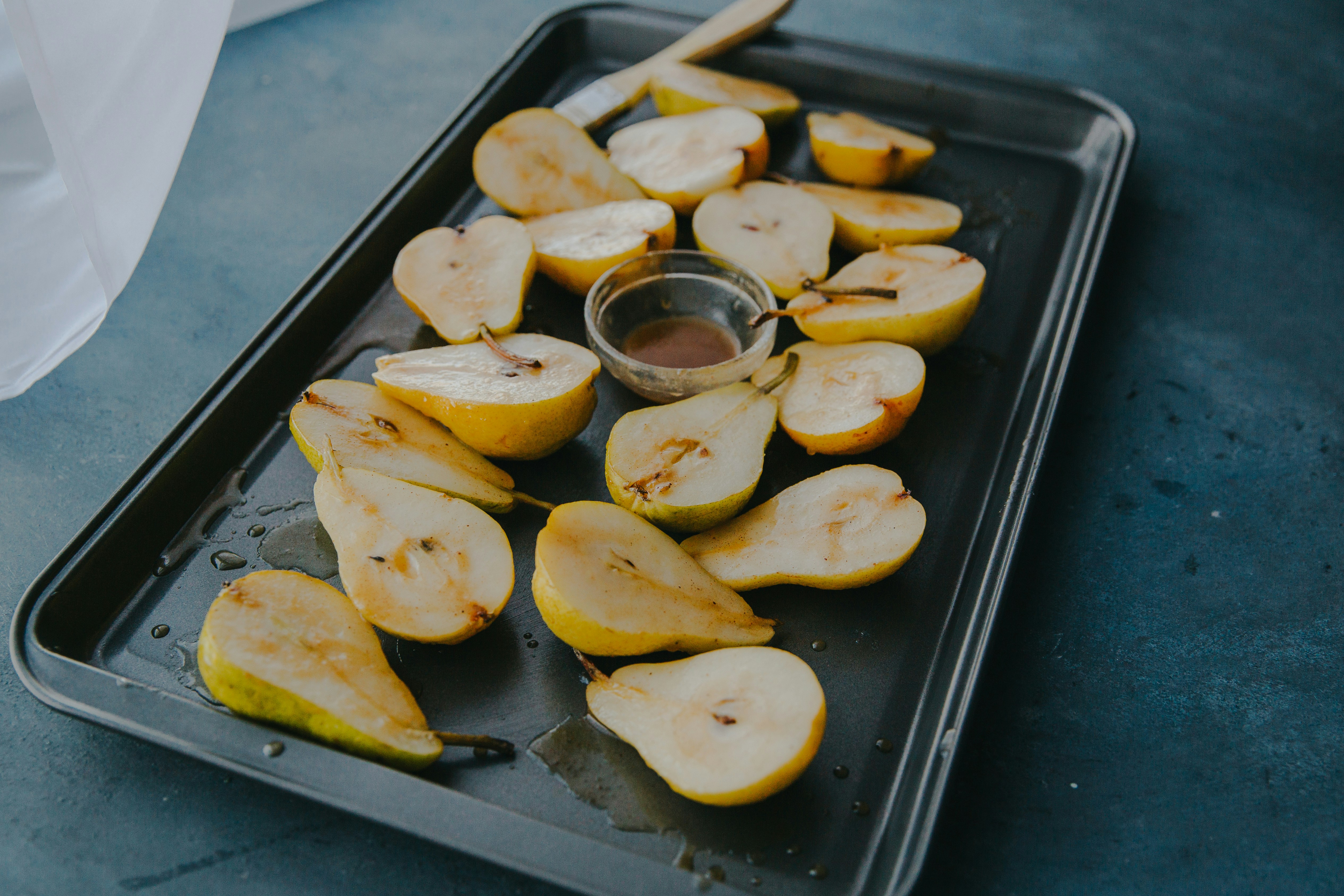 Halved pears on baking tray