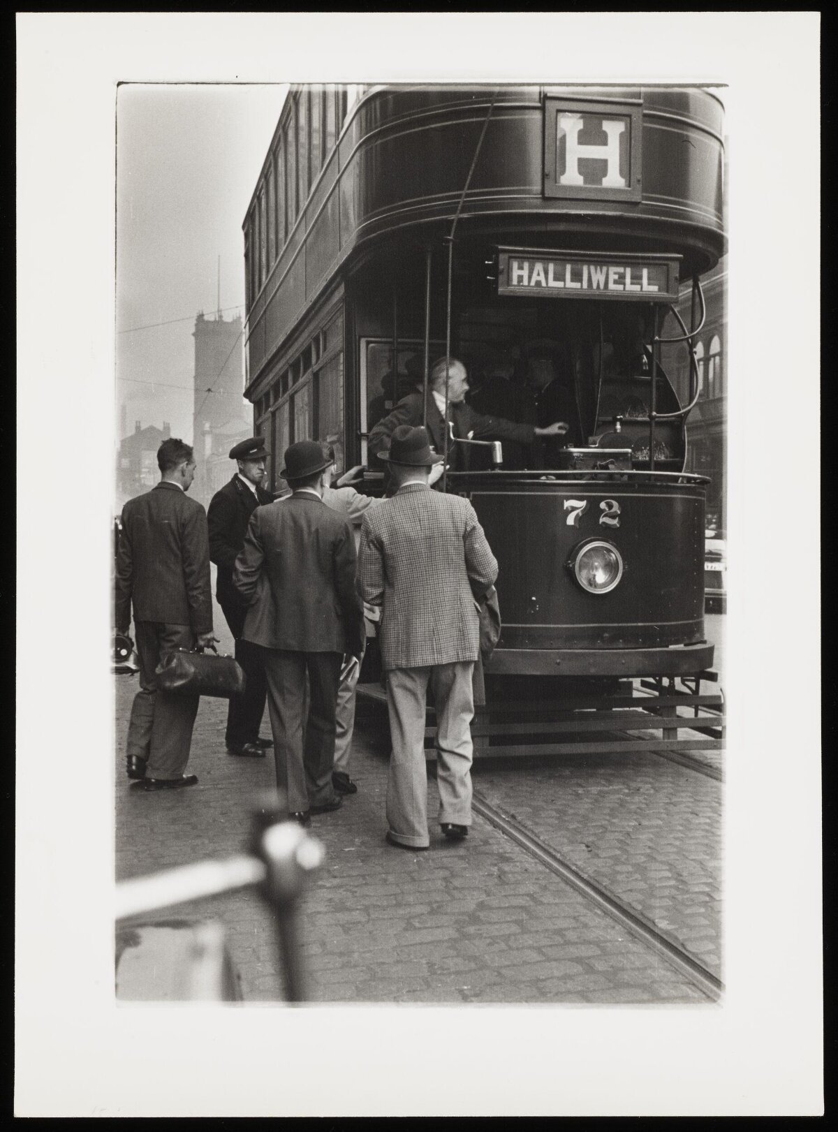 Passengers Boarding Vintage Double-Decker Tram