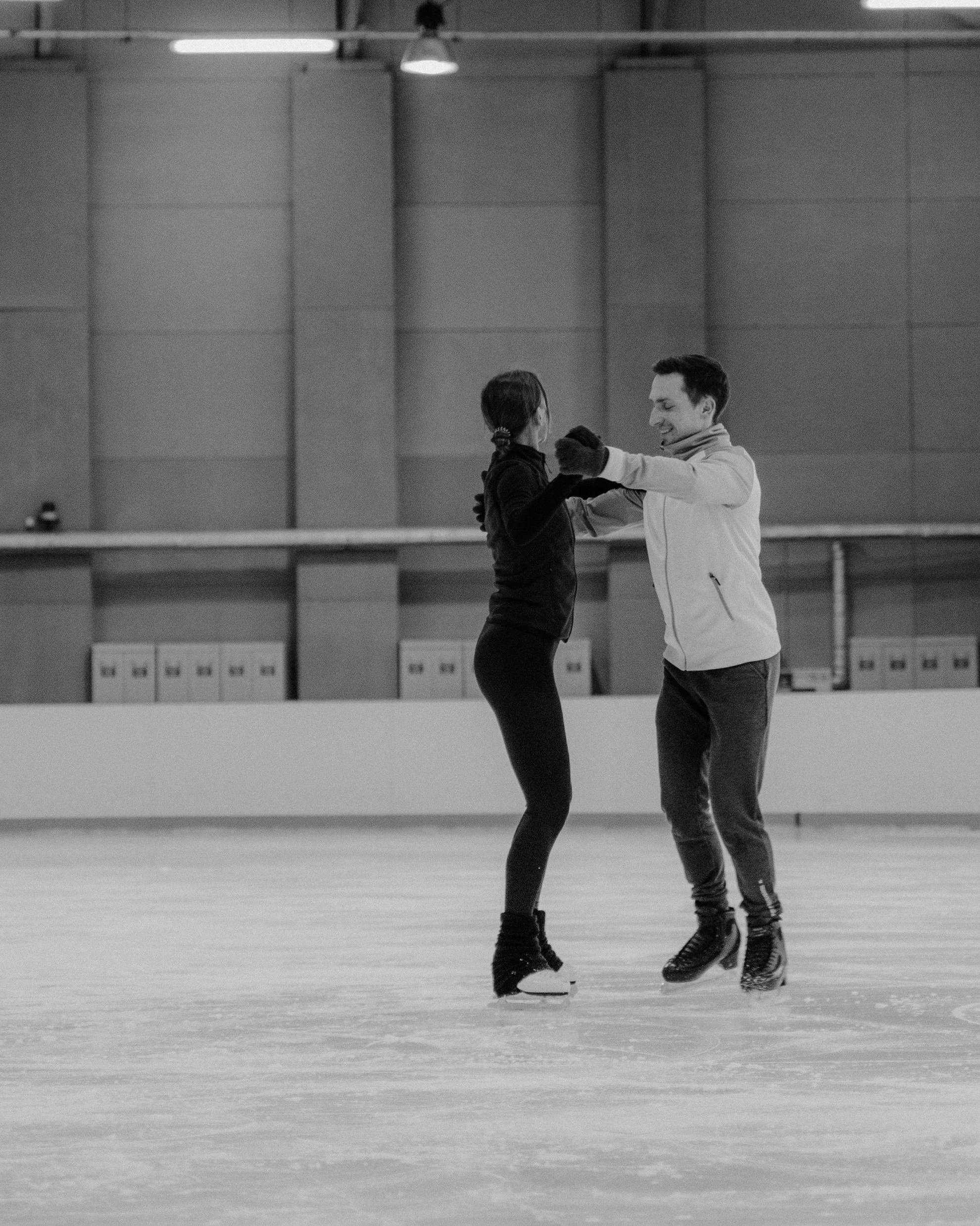 Two Figure Skaters Practicing On Indoor Ice Rink