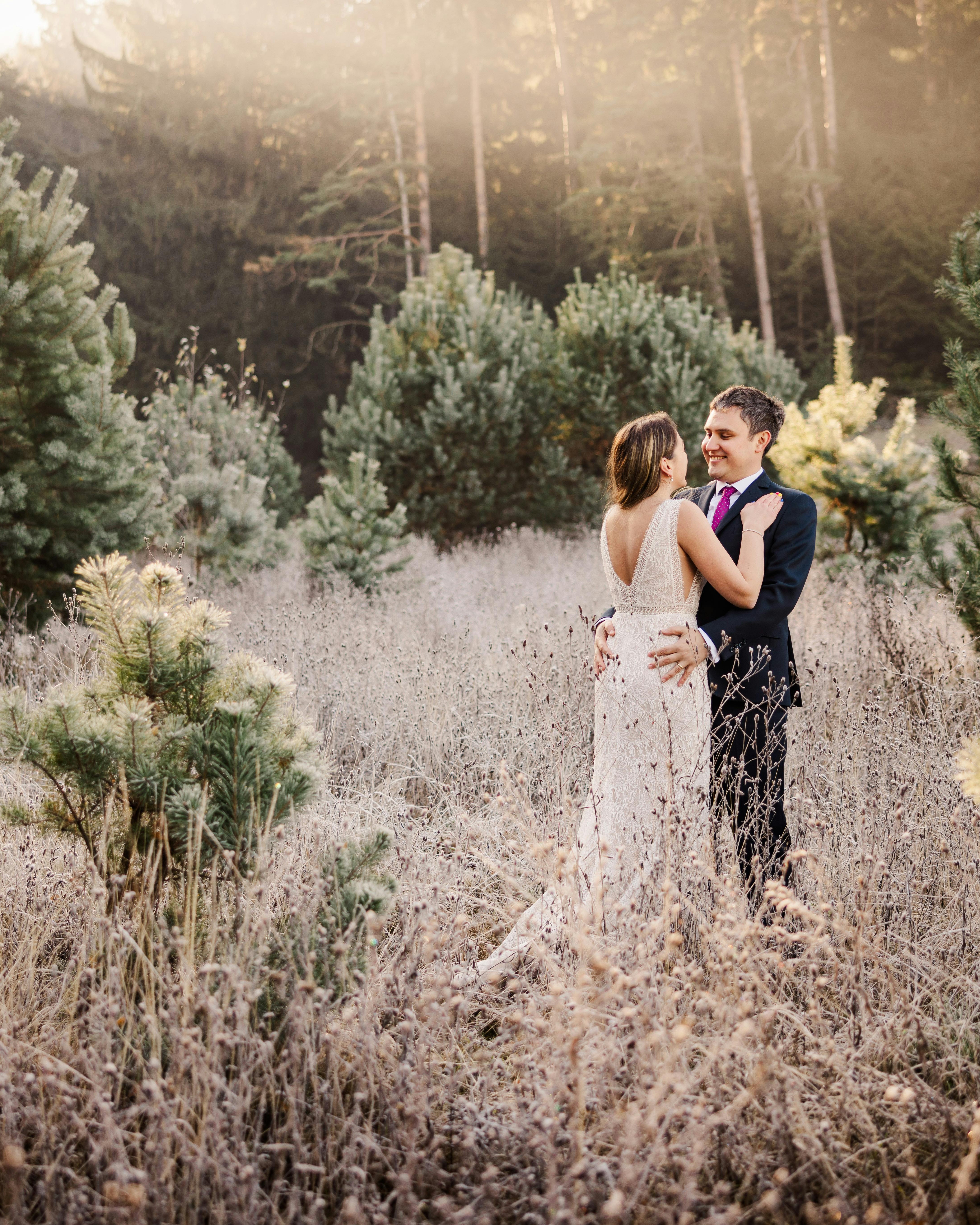 Bride and Groom Embracing in Forest Meadow