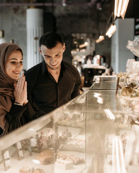 Couple Browsing Bakery Display Case