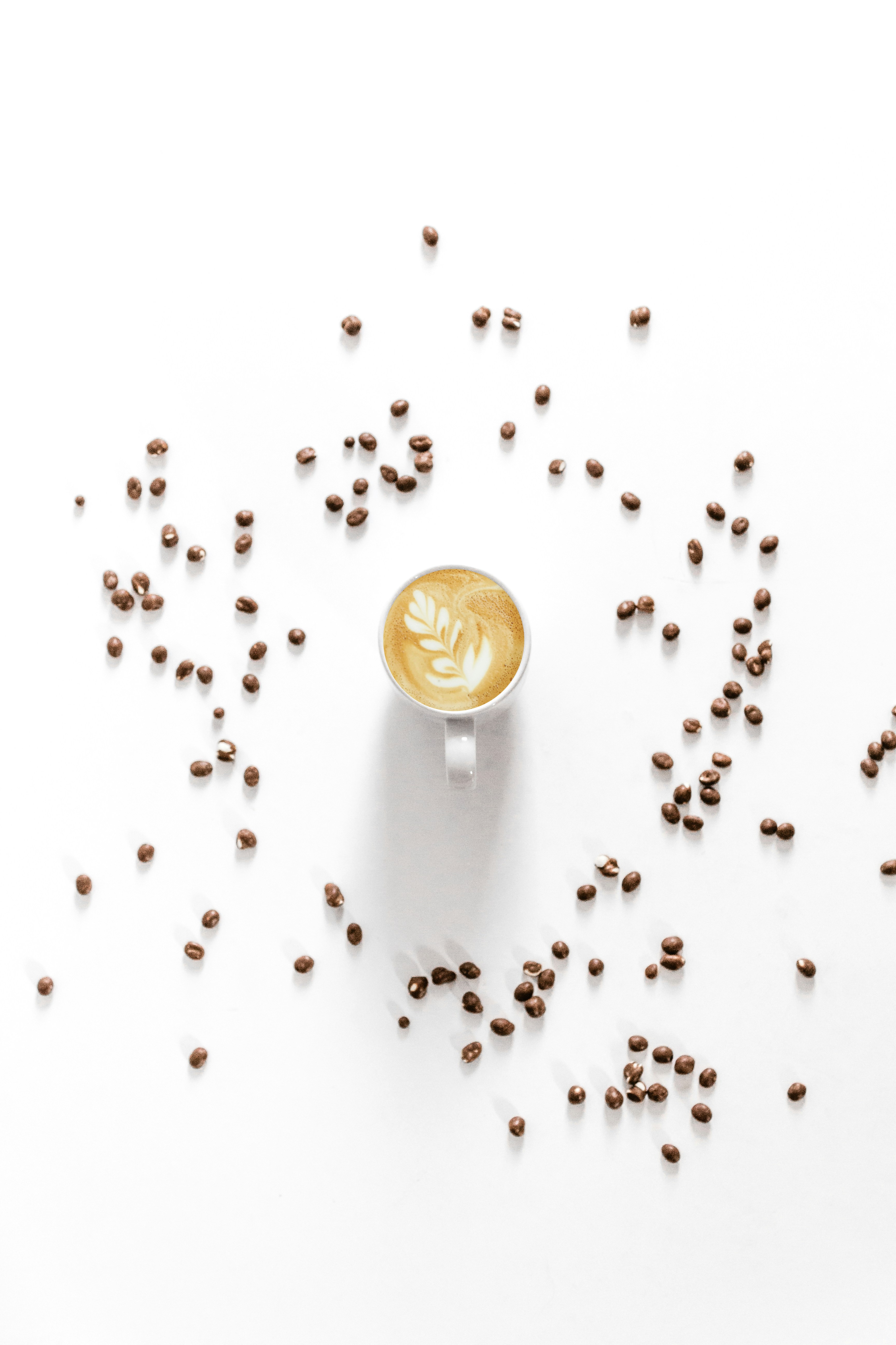 Latte Art Coffee with Scattered Coffee Beans