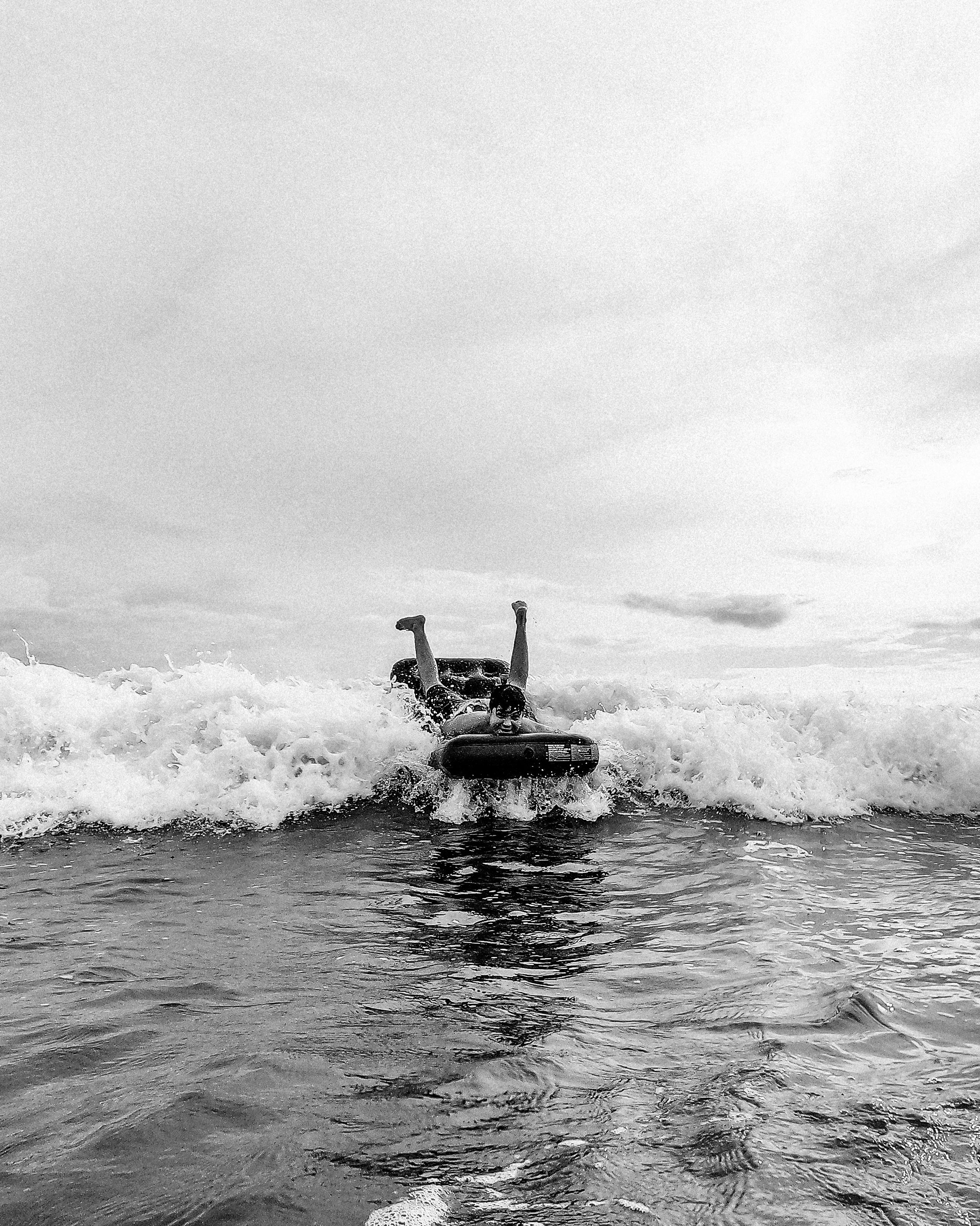 Person Bodyboarding on Ocean Wave