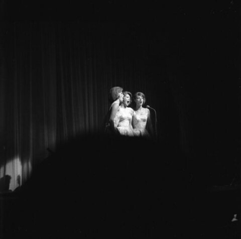 Three Singers Performing on Stage