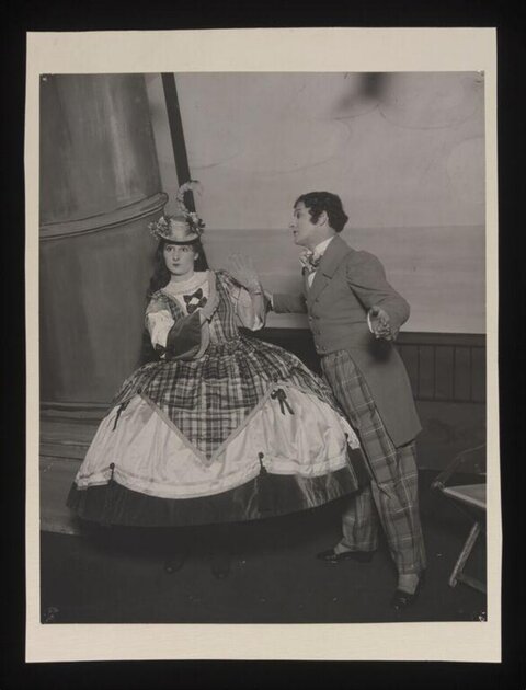 Two Costumed Actors Performing on Stage