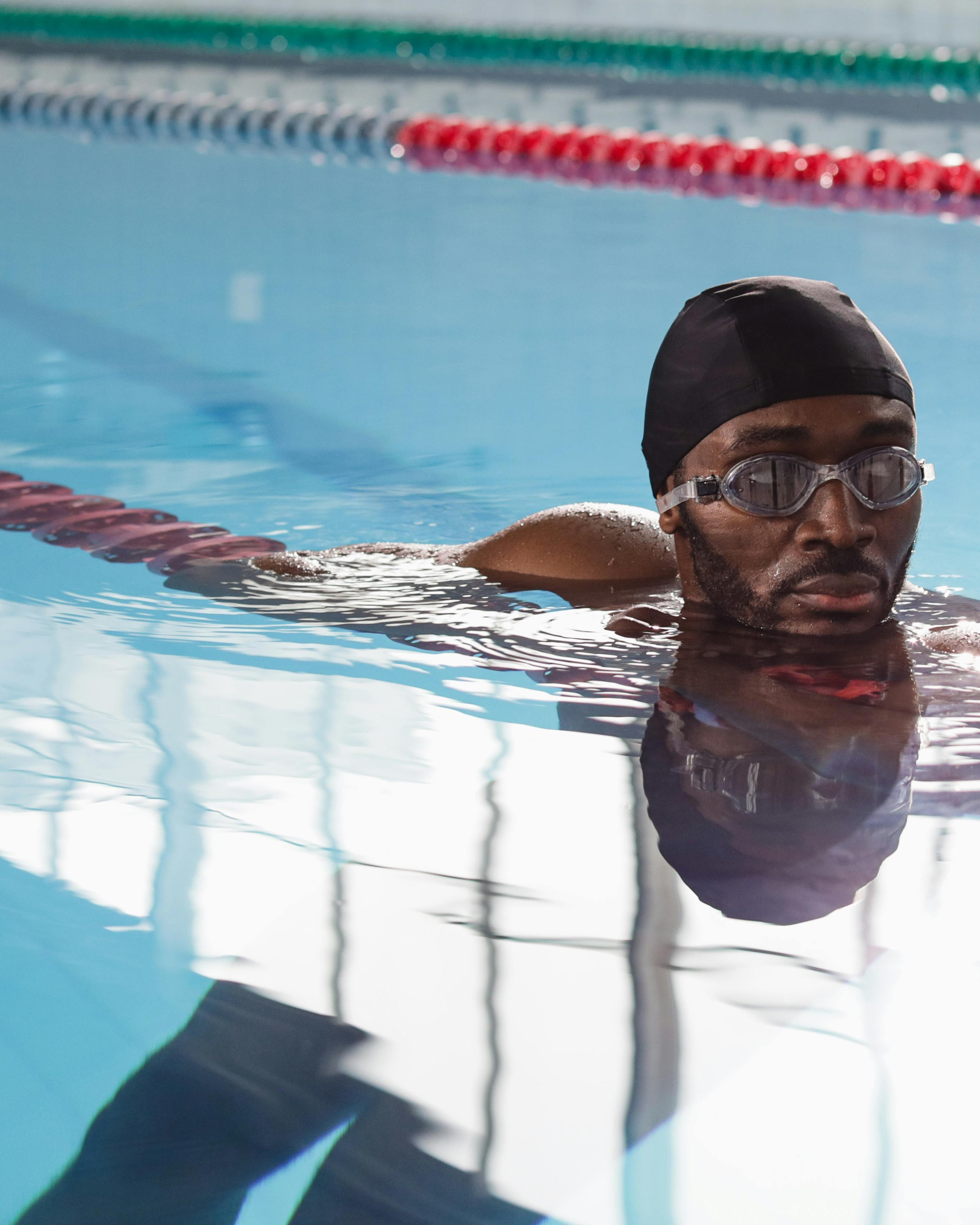 Black Swimmer Resting in Pool Lane