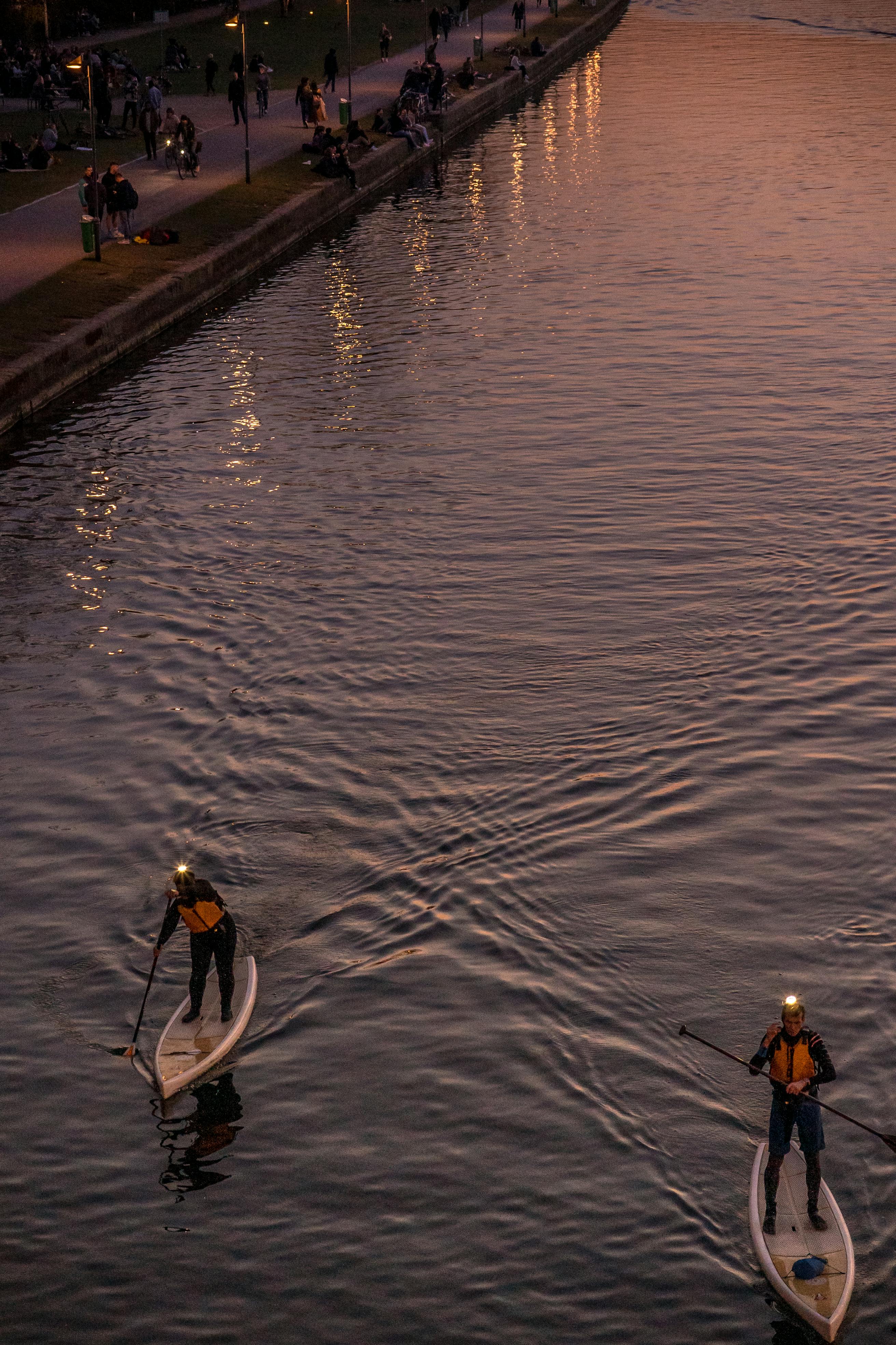 Two Paddleboarders on River at Dusk