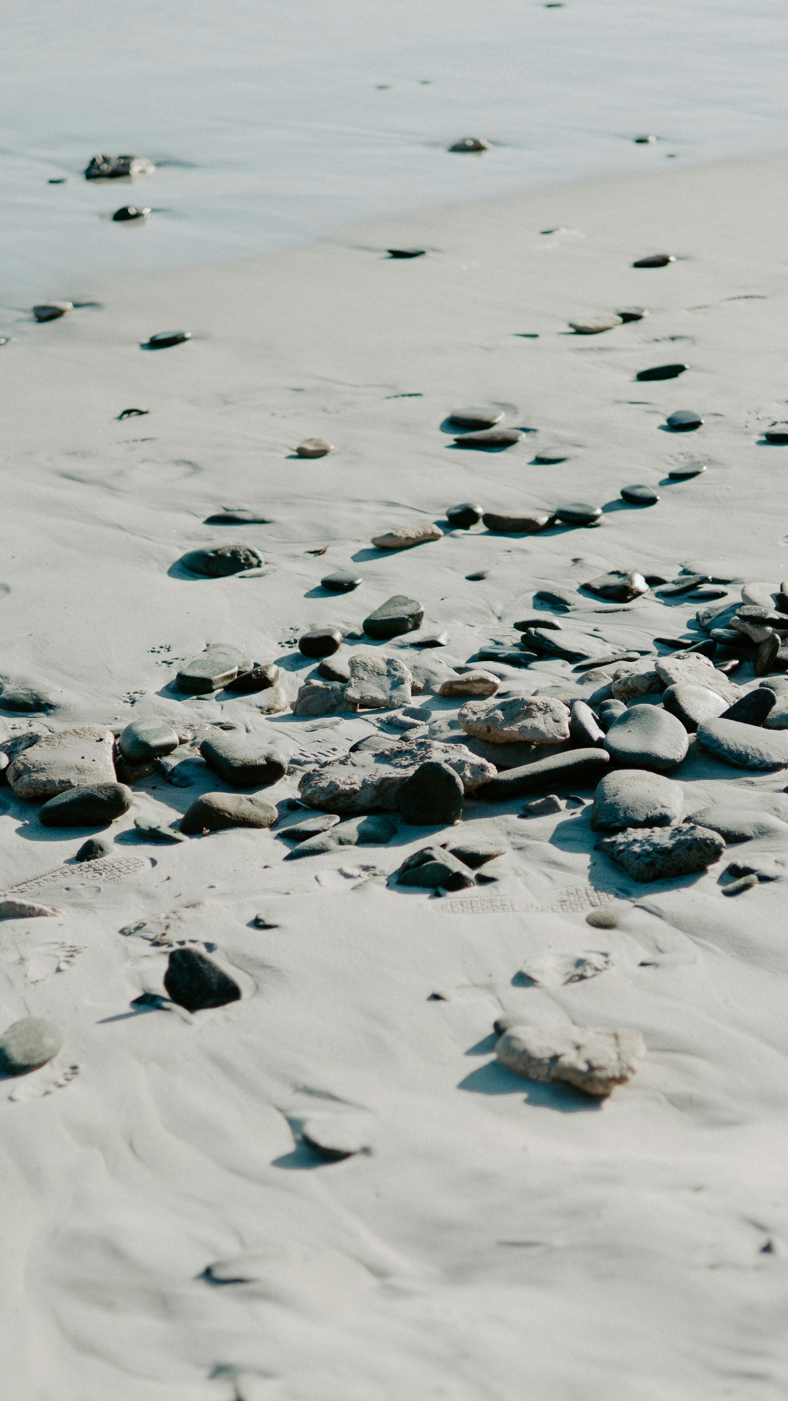 Sandy Beach with Scattered Pebbles