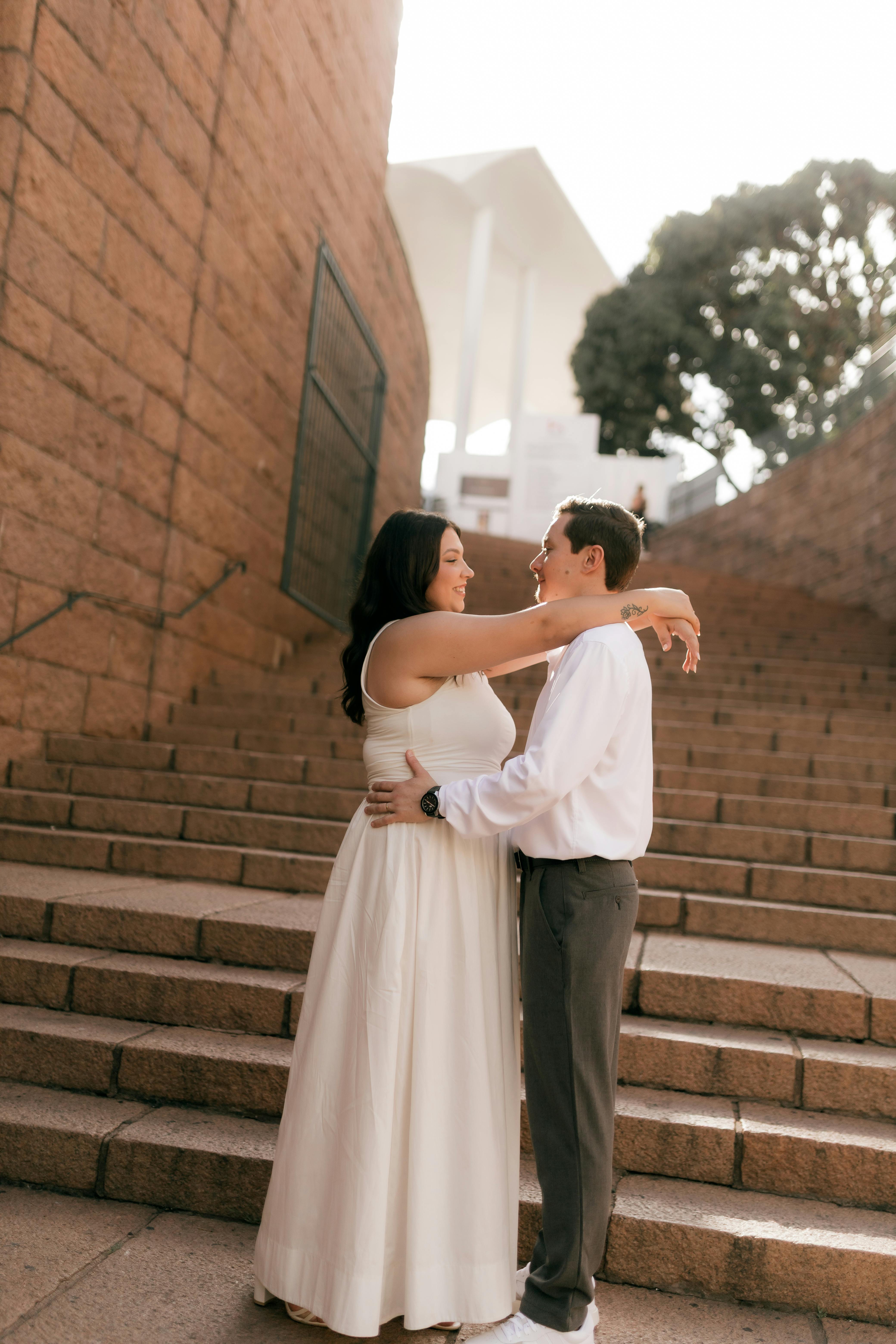 Engaged Couple Embracing on Stone Steps