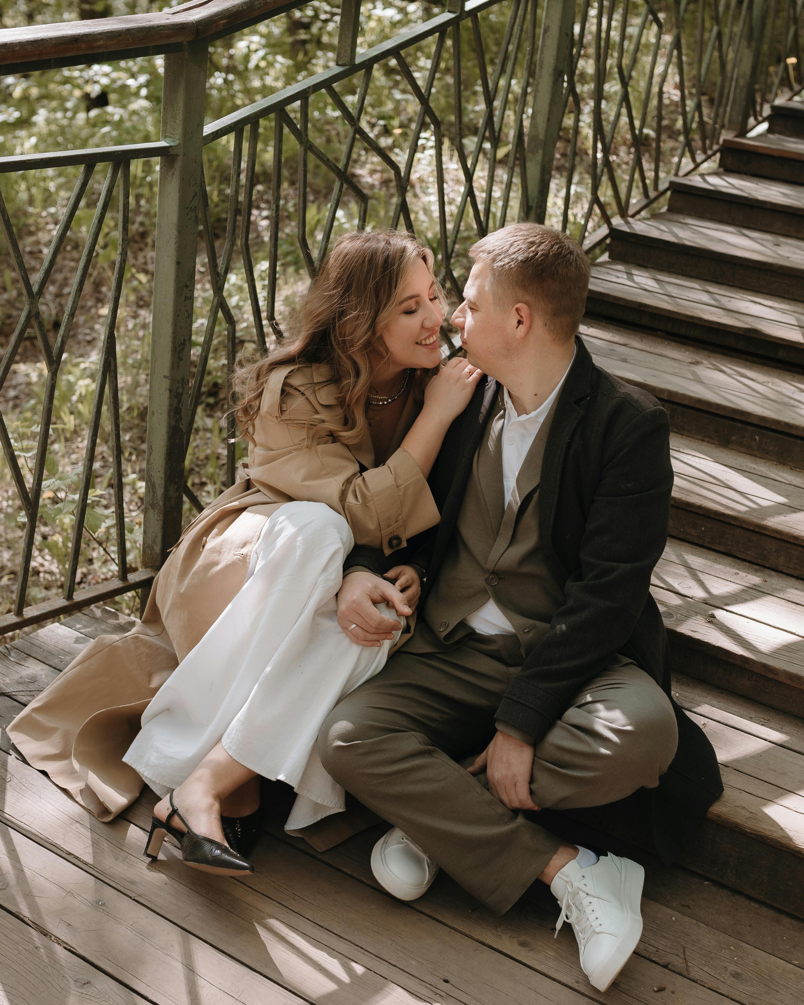 Couple Cuddling on Outdoor Wooden Stairs