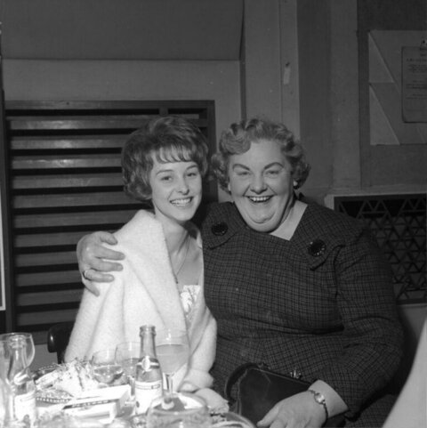 Two Joyful Women at a Dinner Gathering