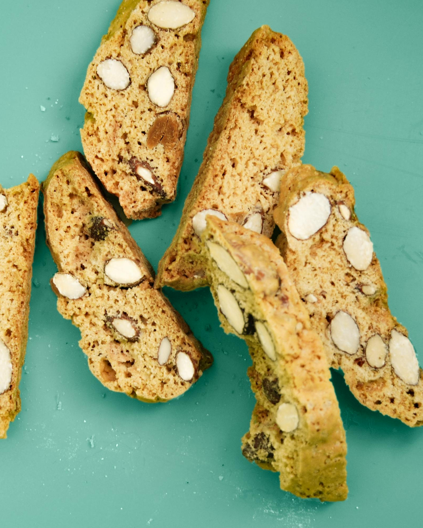 Sliced Almond Biscotti on Teal Background