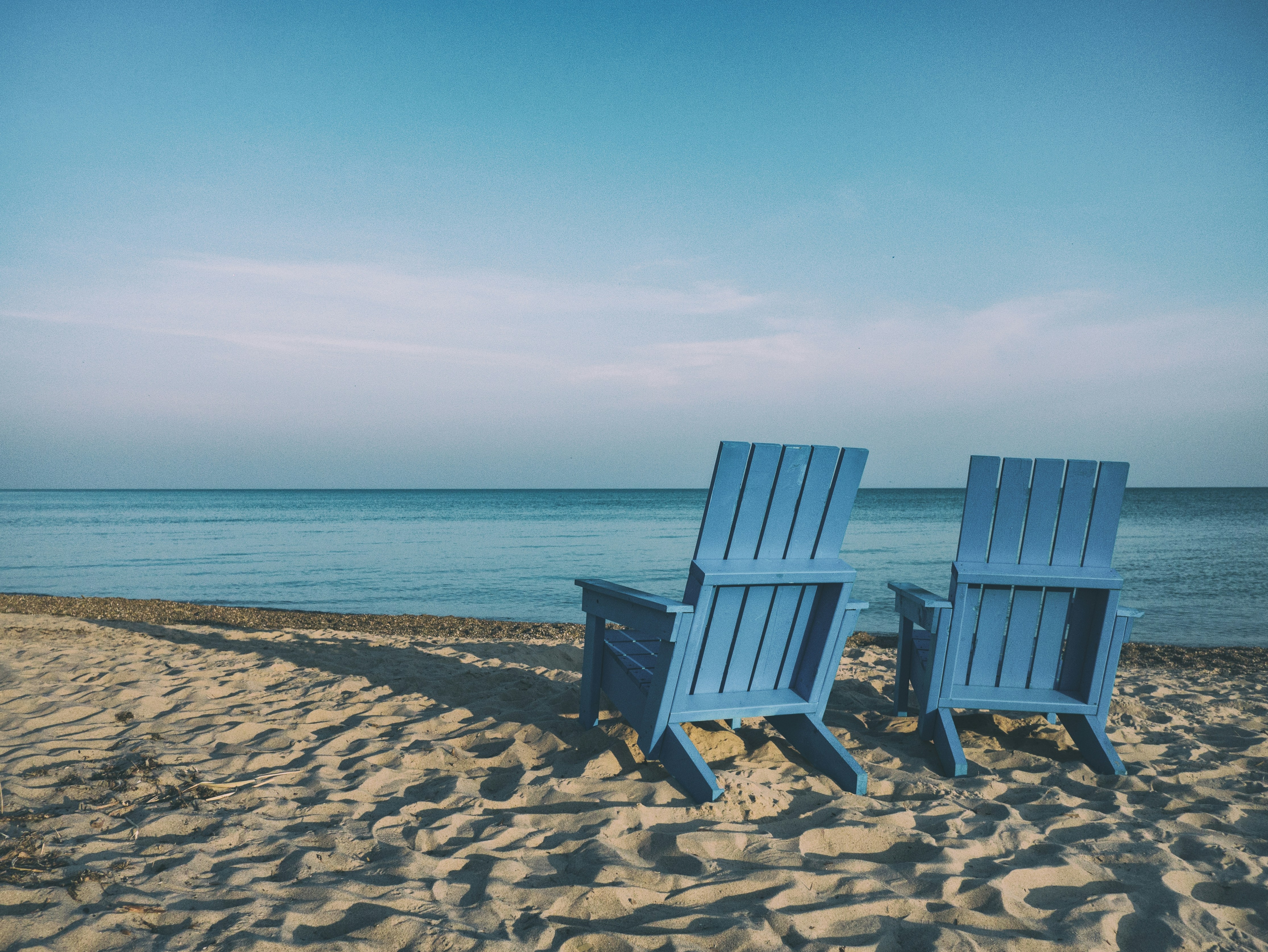 Two Blue Beach Chairs On Seashore
