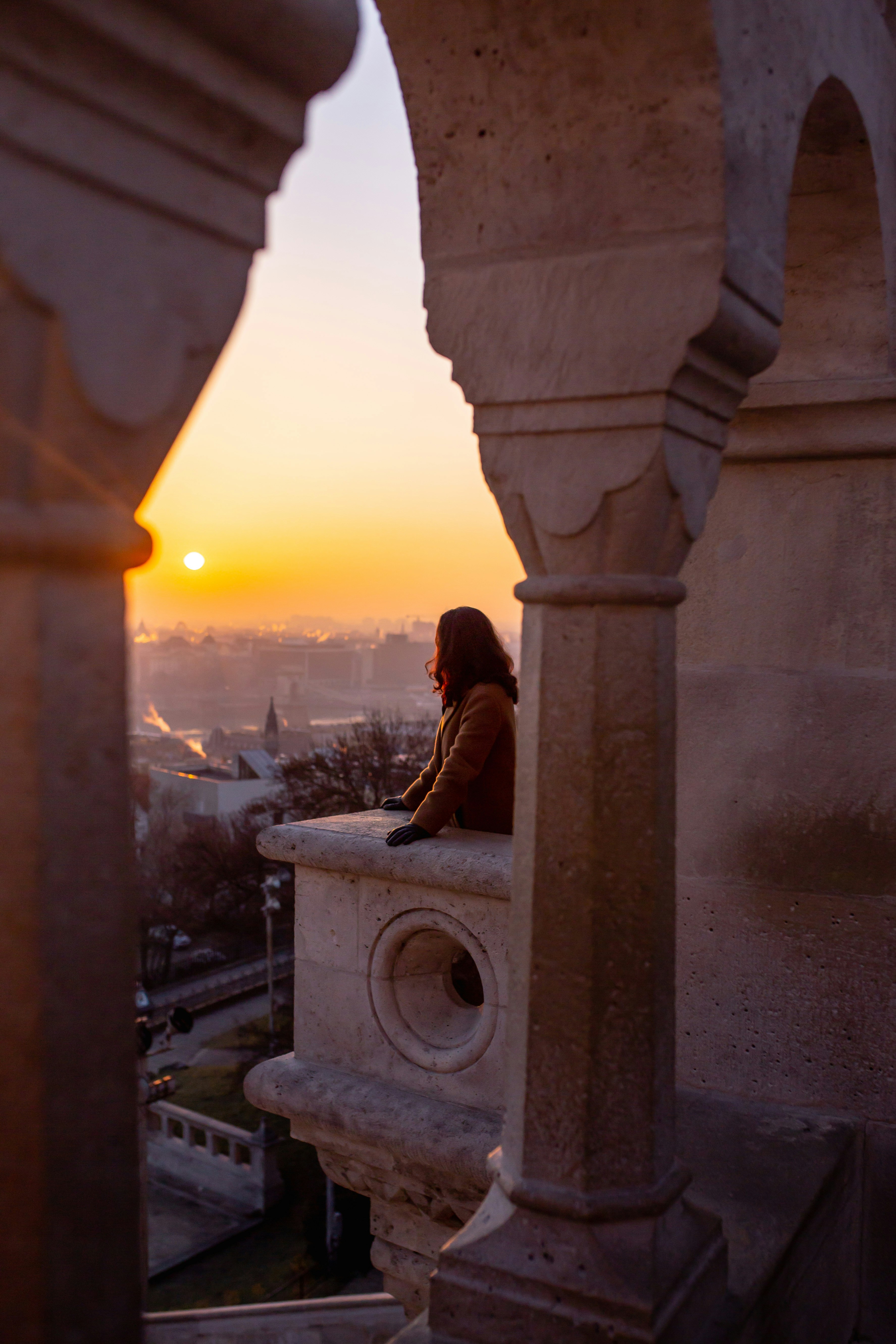 Woman Watching Sunset Over City