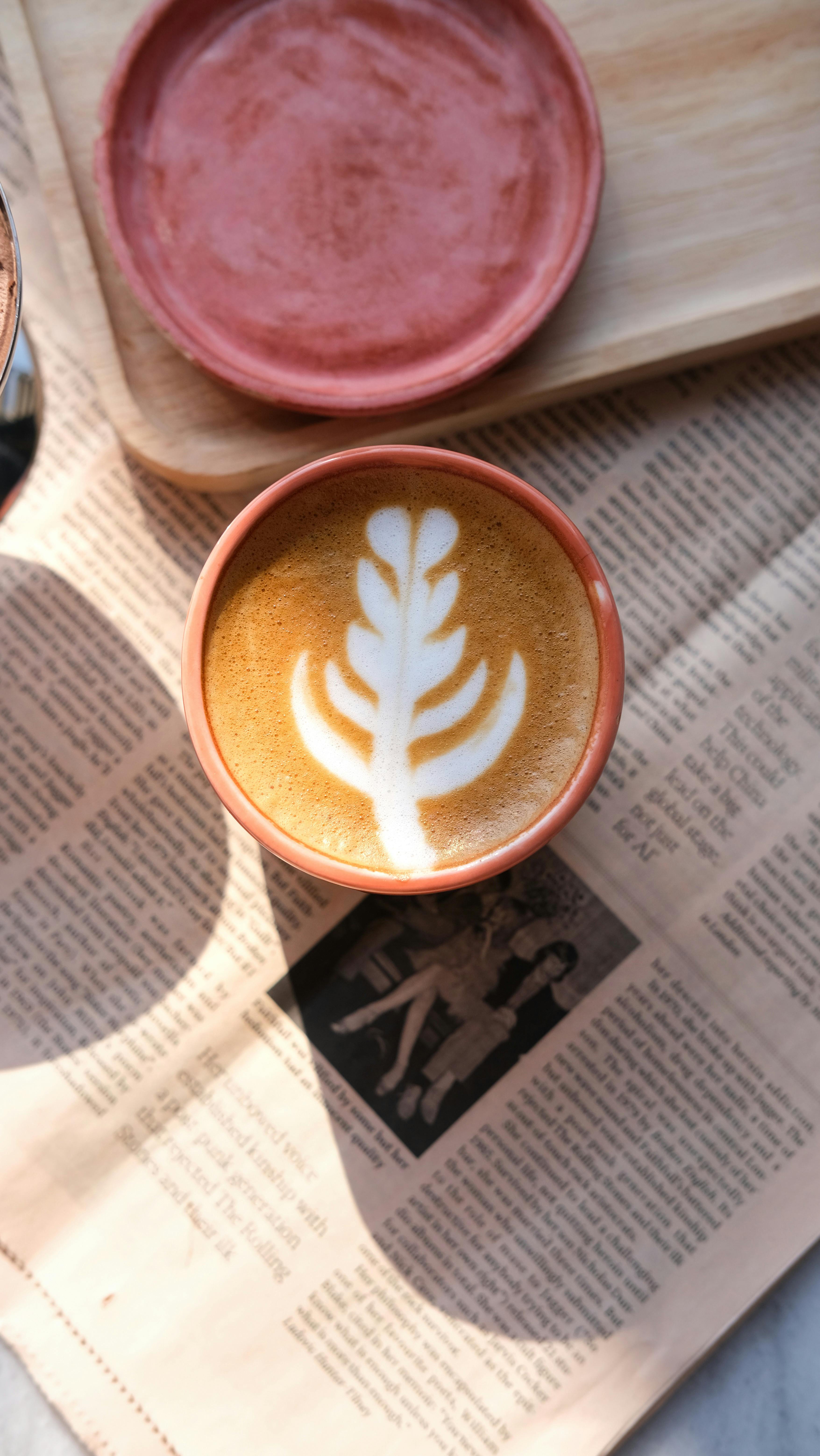 Leaf Latte Art Coffee on Newspaper
