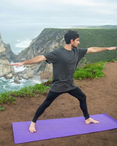 Man Doing Yoga on Coastal Cliff