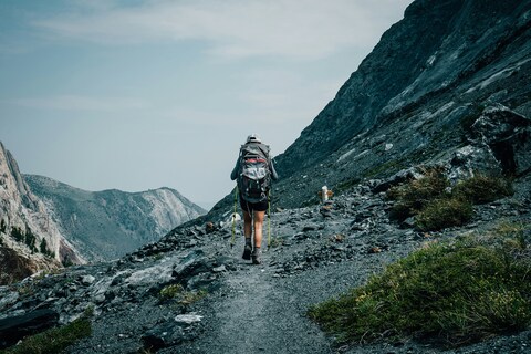 Hiker Trekking on Rocky Mountain Trail