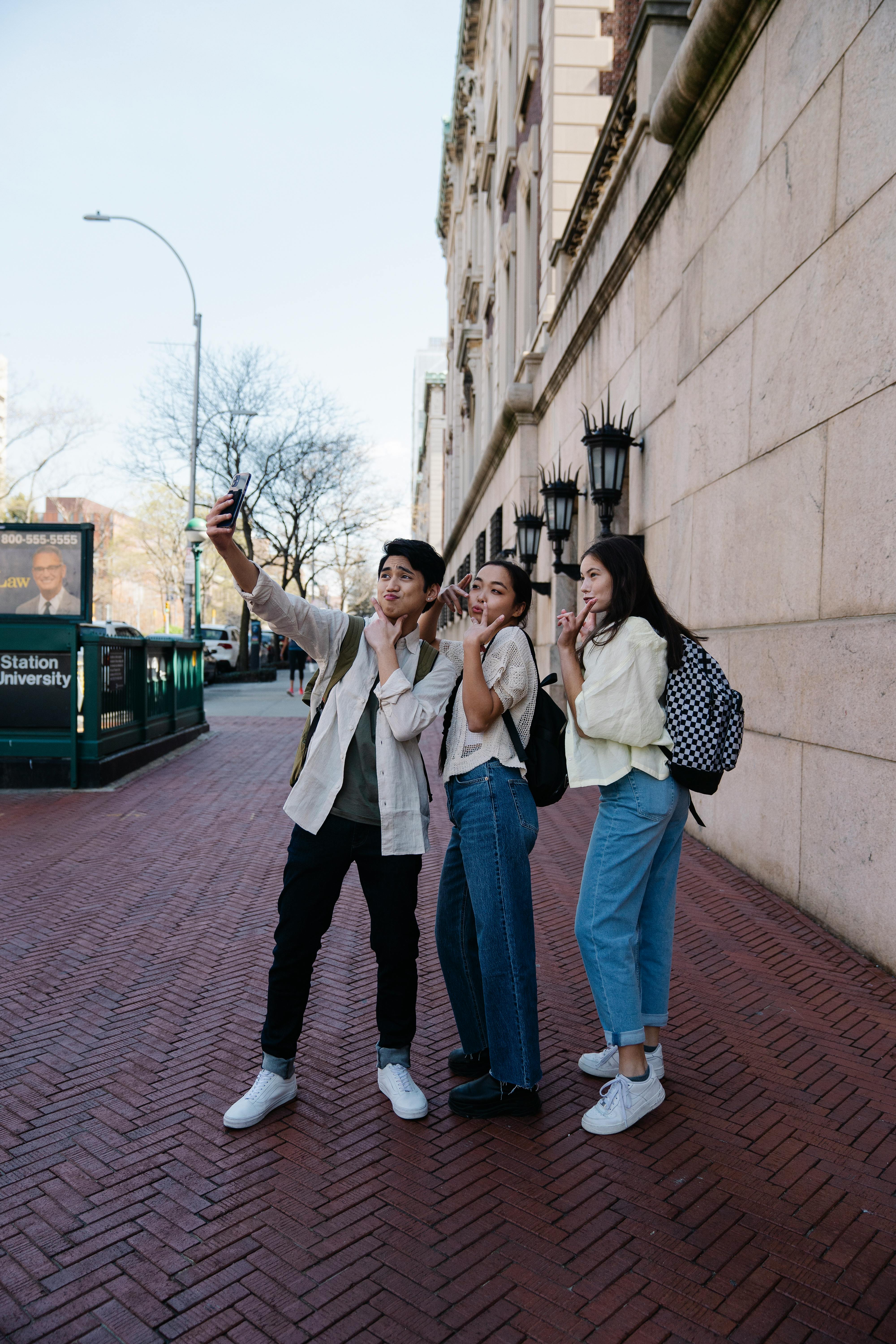 Three Friends Taking Selfie on University Campus
