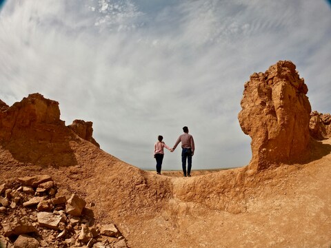 Couple Holding Hands at Red Cliffs
